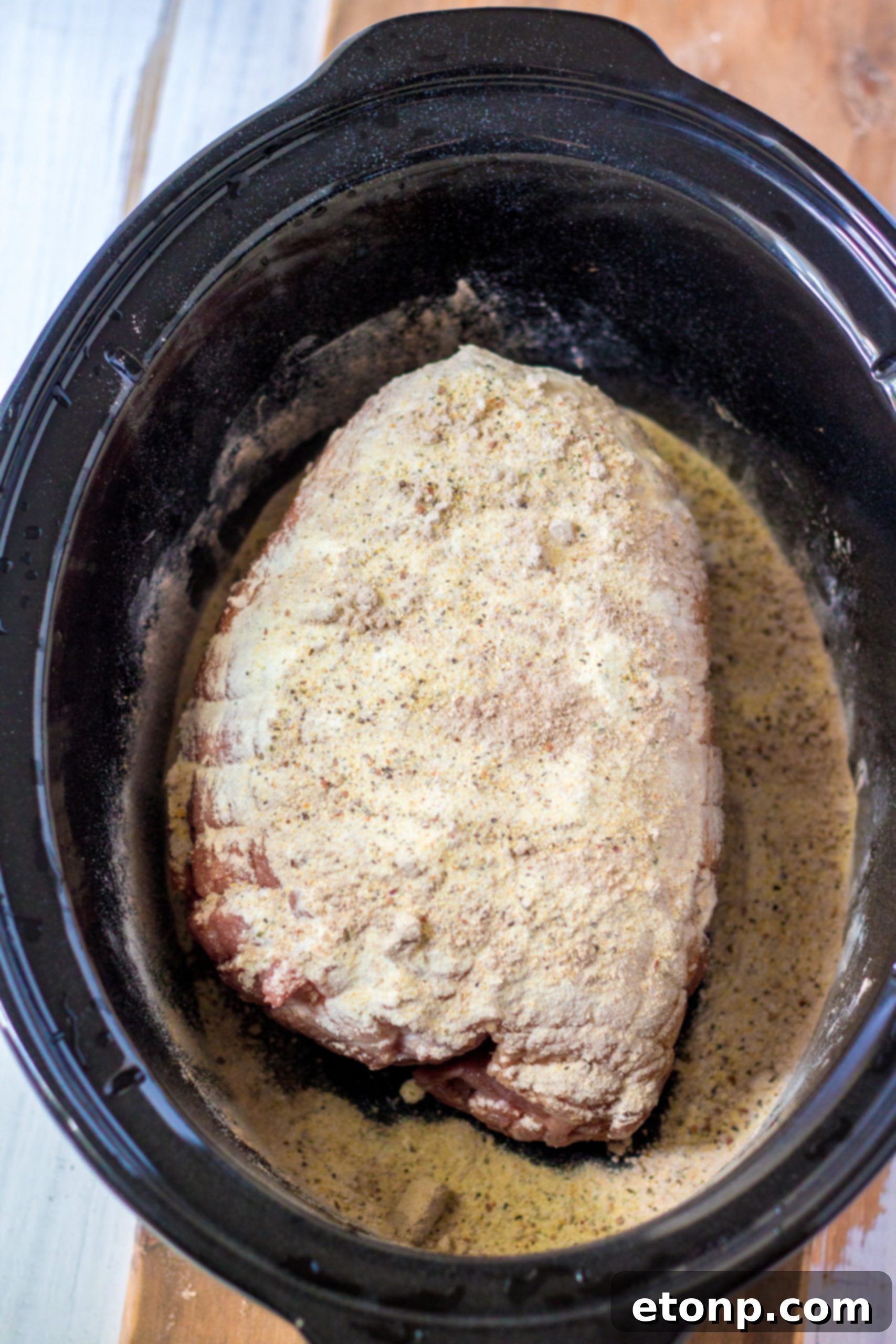 Slow cooker 3 packet pork roast simmering, showing the rich liquid and seasoned meat