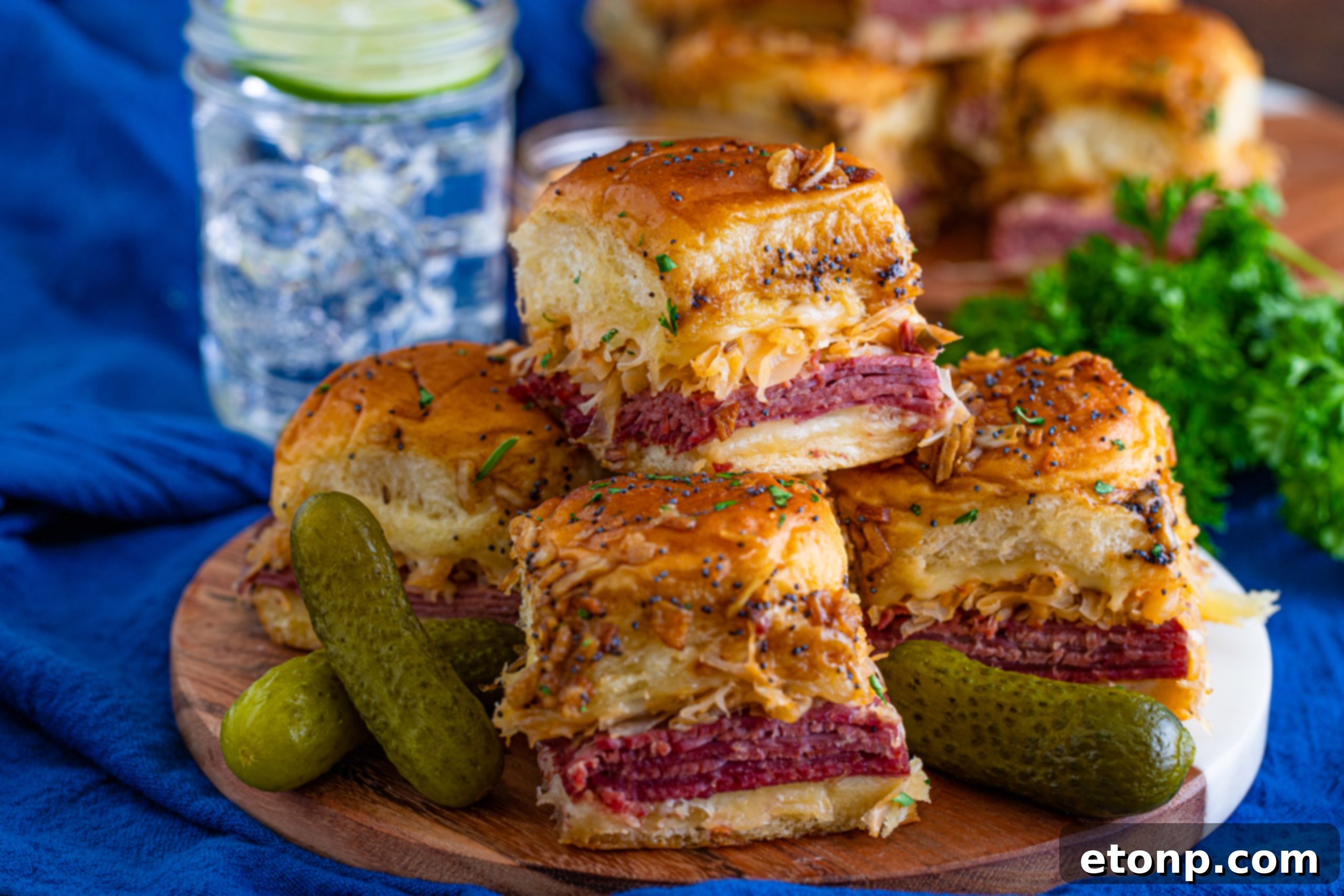 Mini Reuben Sandwiches 11 Several Reuben Sliders plated, showcasing the melted cheese and juicy corned beef filling, ready to be eaten.