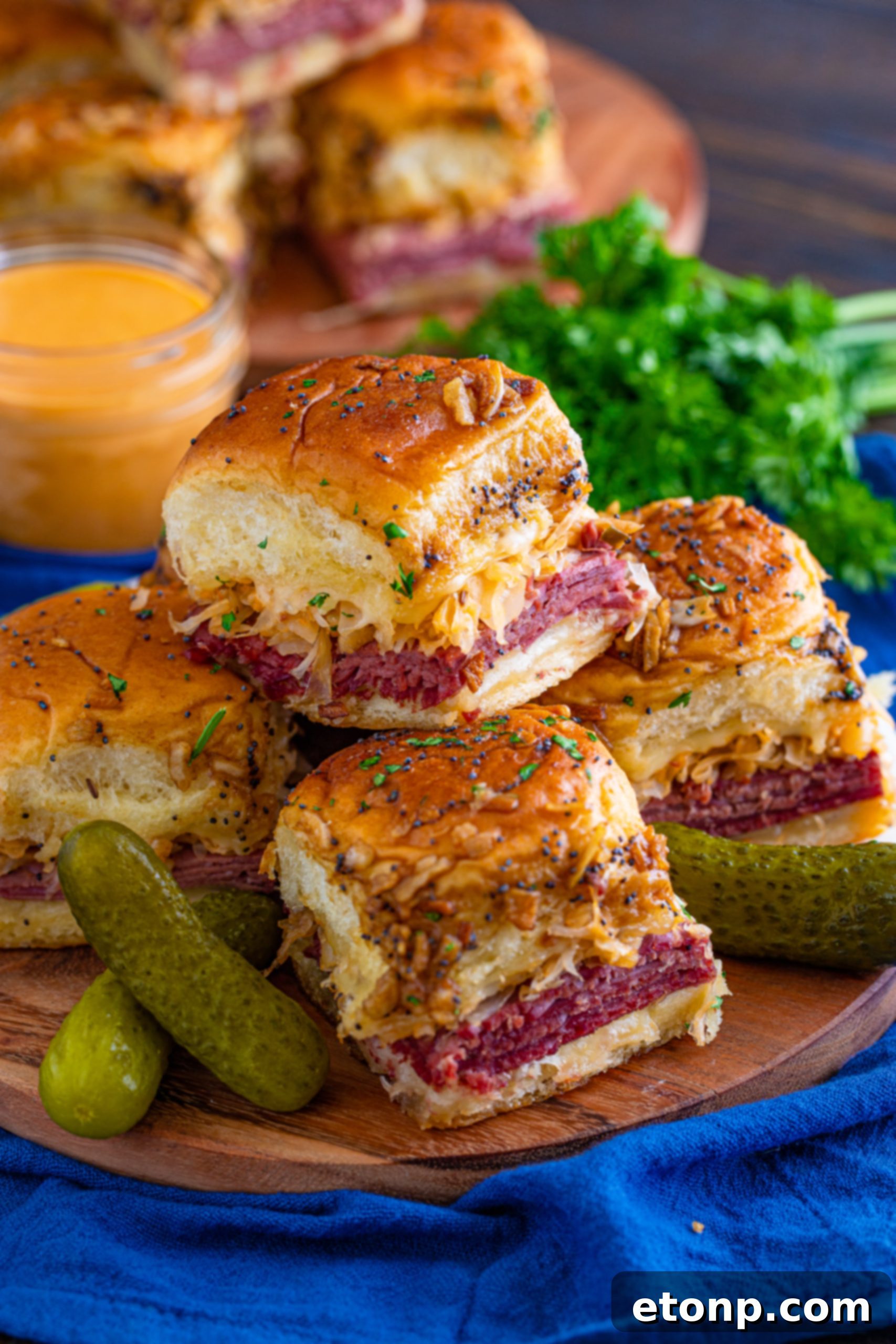 Mini Reuben Sandwiches 16 A stack of three golden brown Reuben Sliders, showcasing their delicious layers and perfectly baked tops.