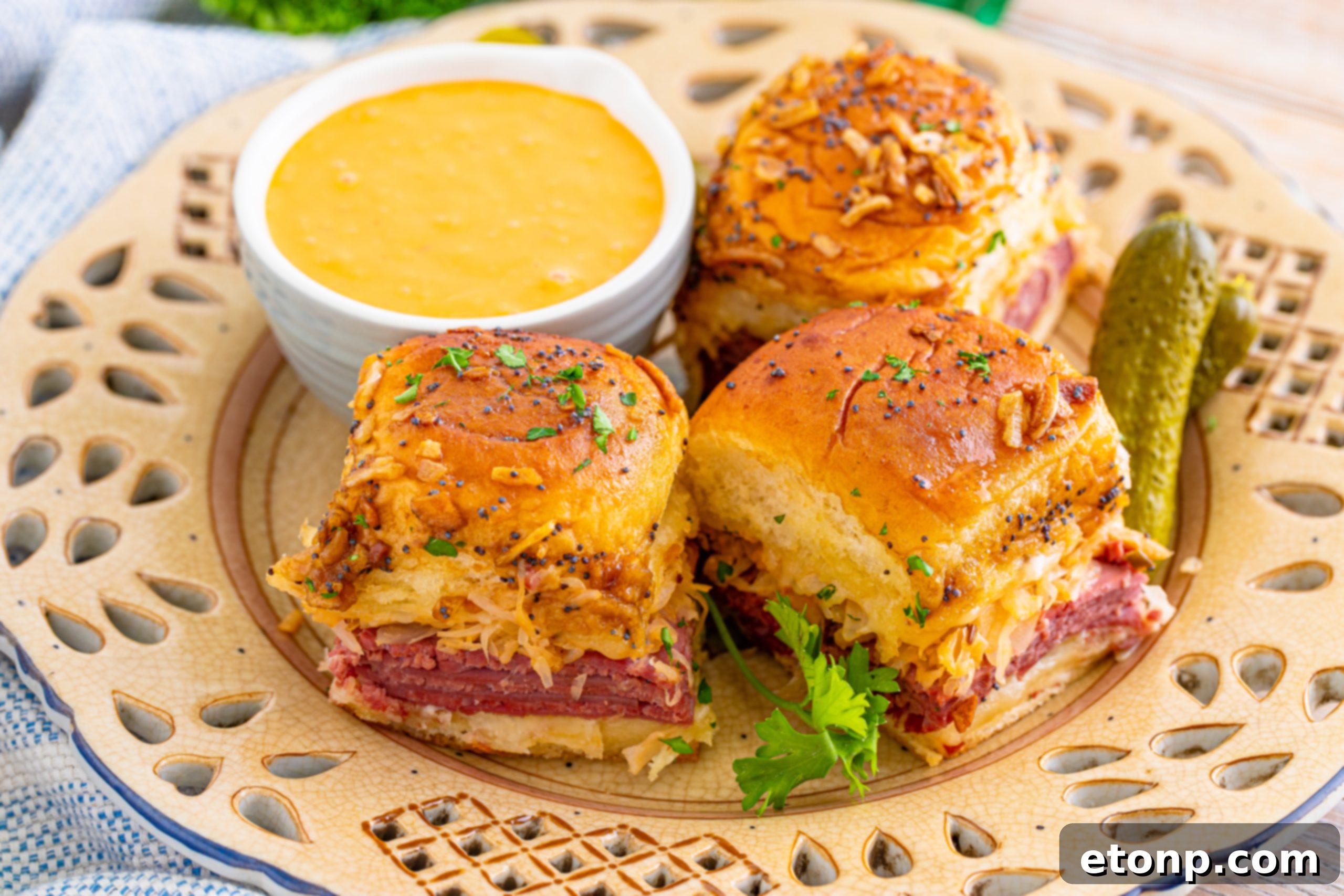 Mini Reuben Sandwiches 17 A close-up of a single Reuben Slider being pulled apart, showing the gooey melted cheese and tender corned beef.