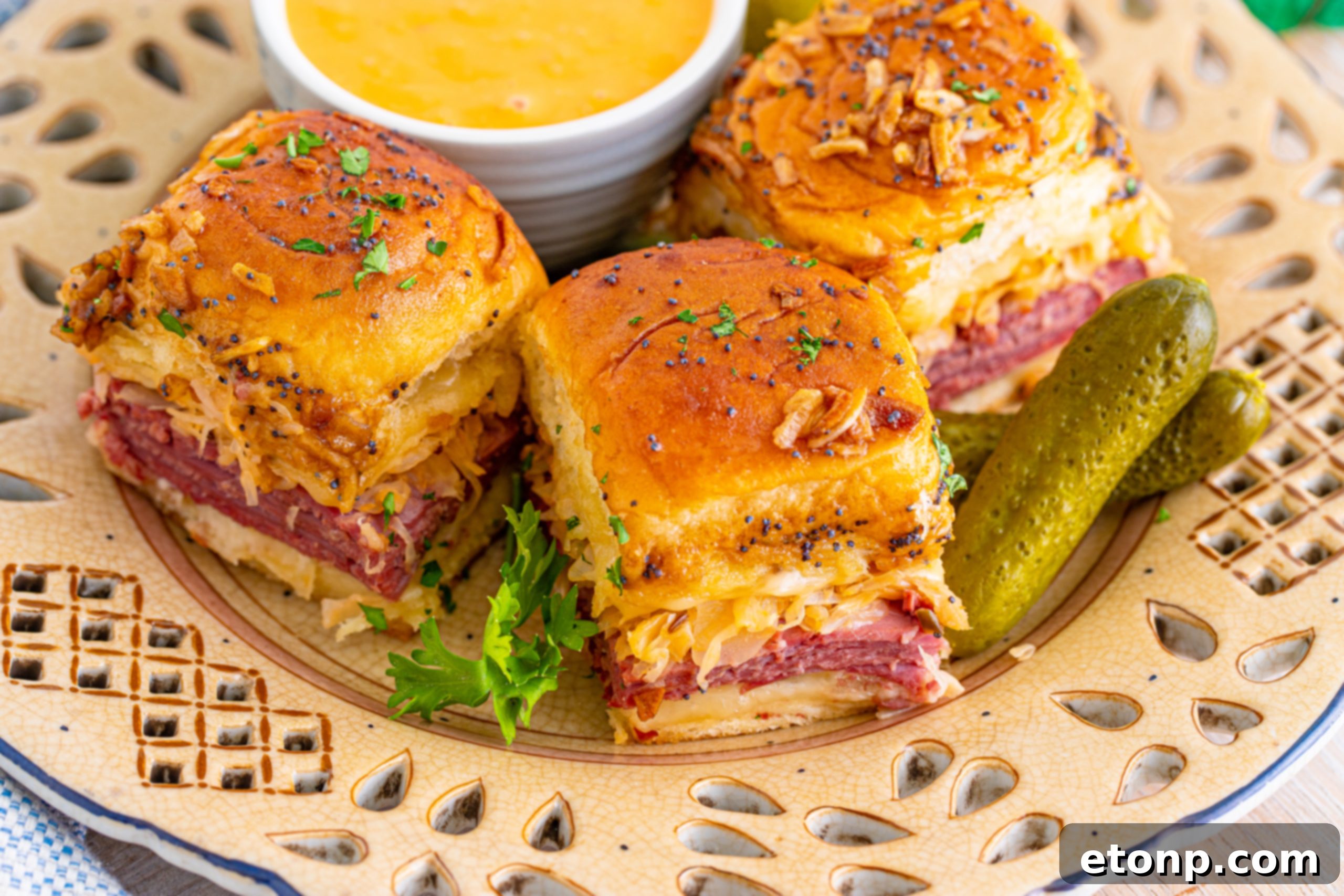 Mini Reuben Sandwiches 18 A baking dish filled with many Reuben Sliders, just out of the oven, steaming hot and ready to be served.