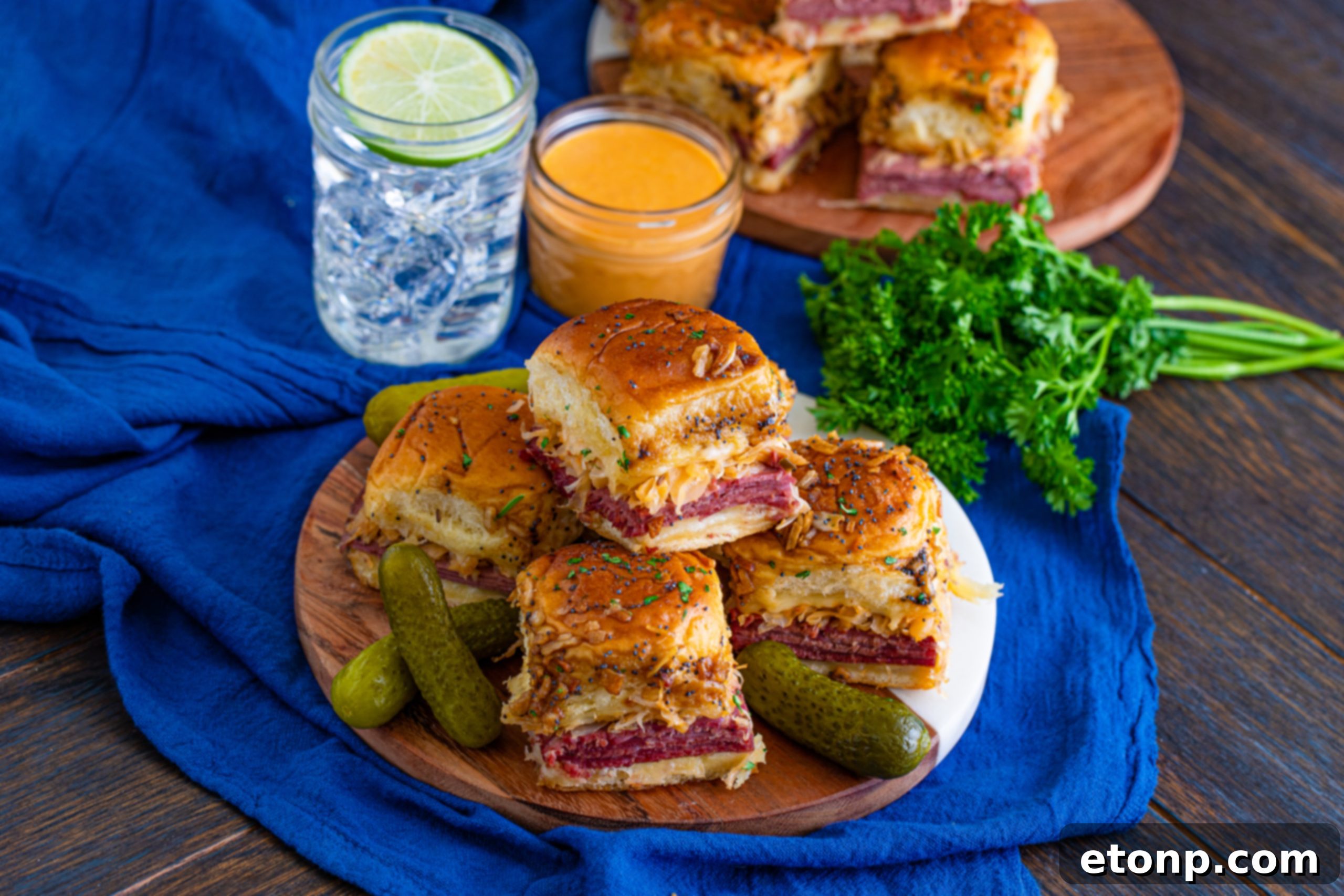 Mini Reuben Sandwiches 9 Reuben Sliders baking in a dish, showing the tops browning to a golden hue and the cheese melting perfectly.