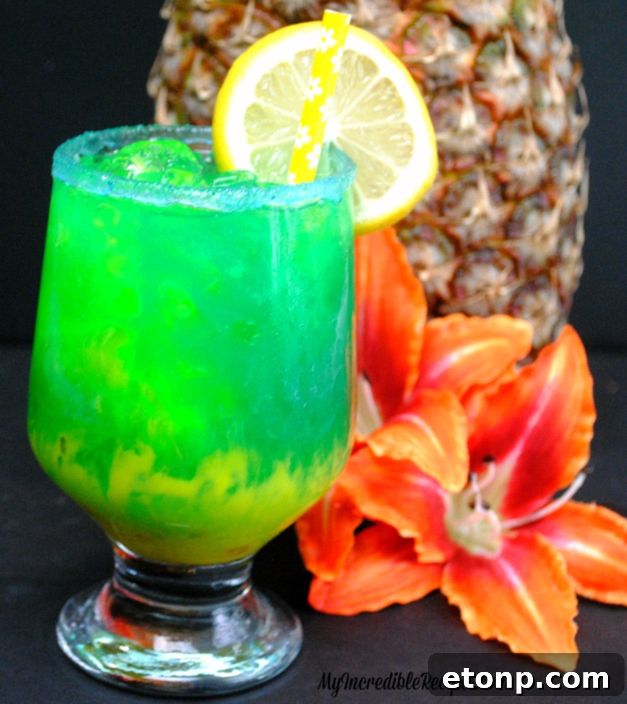 Close-up of a Lava Cocktail with a lemon slice garnish, showcasing the drink's vibrant colors
