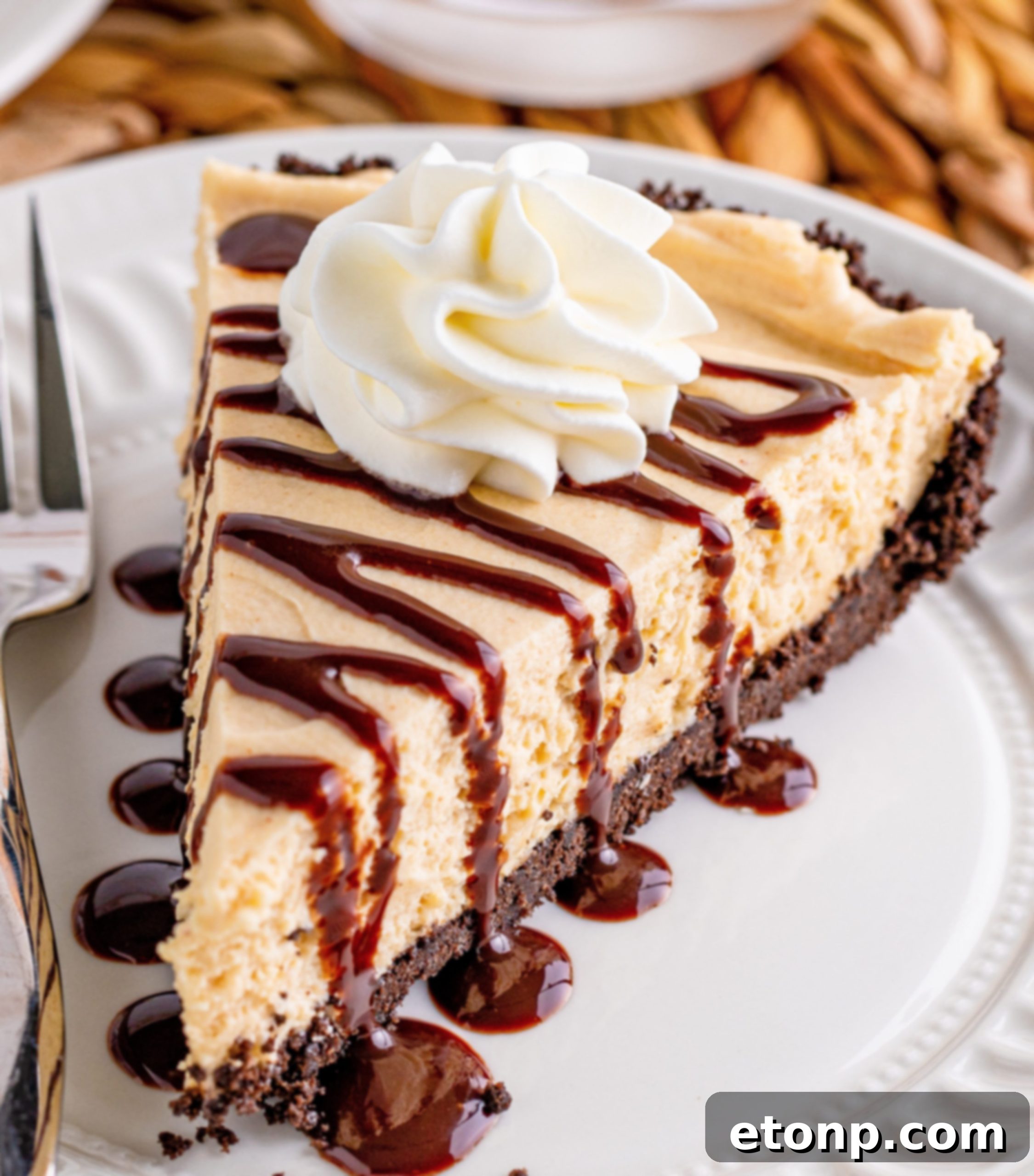 Hand holding a slice of No Bake Peanut Butter Pie