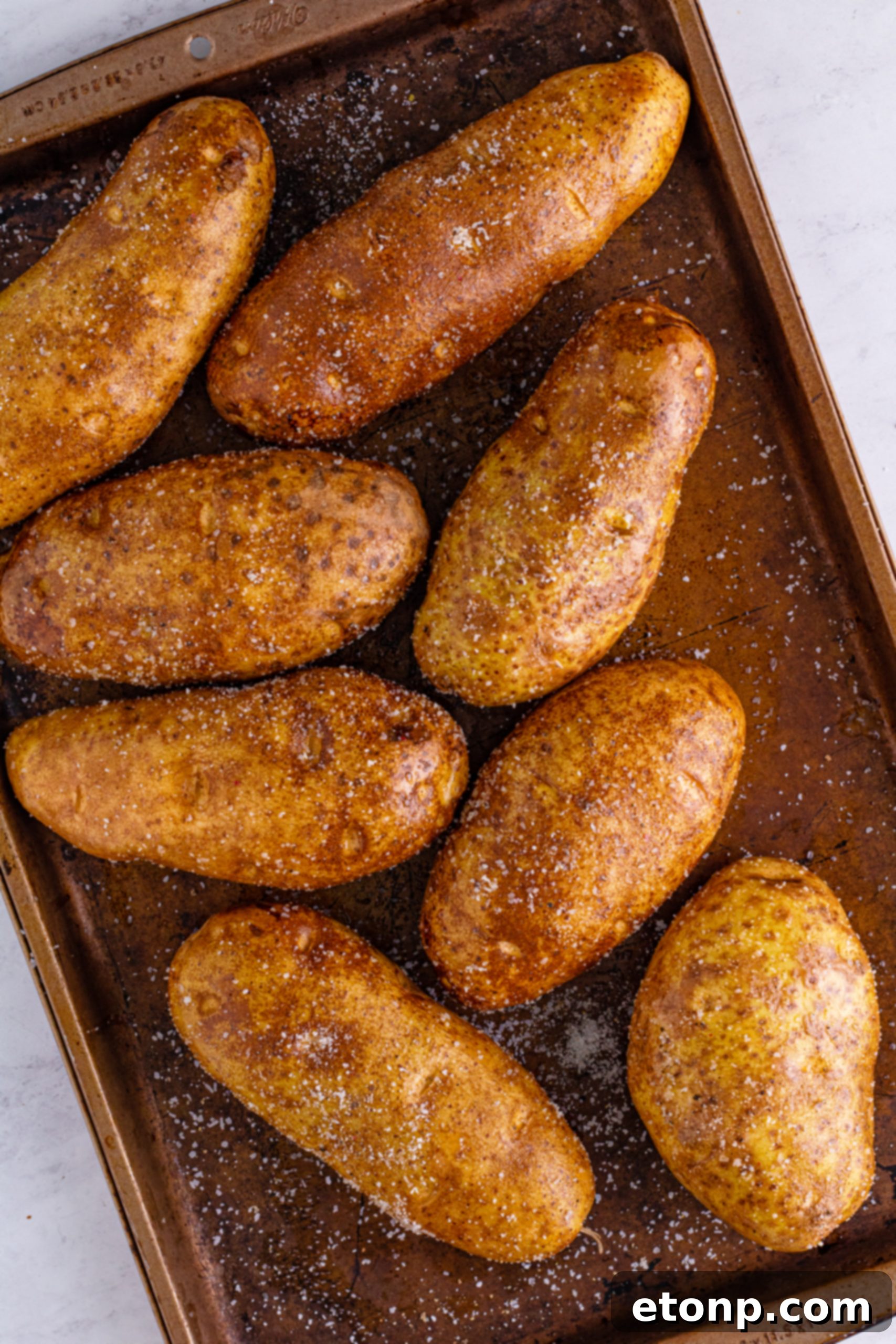 Baked potatoes wrapped in foil, ready for the slow cooker