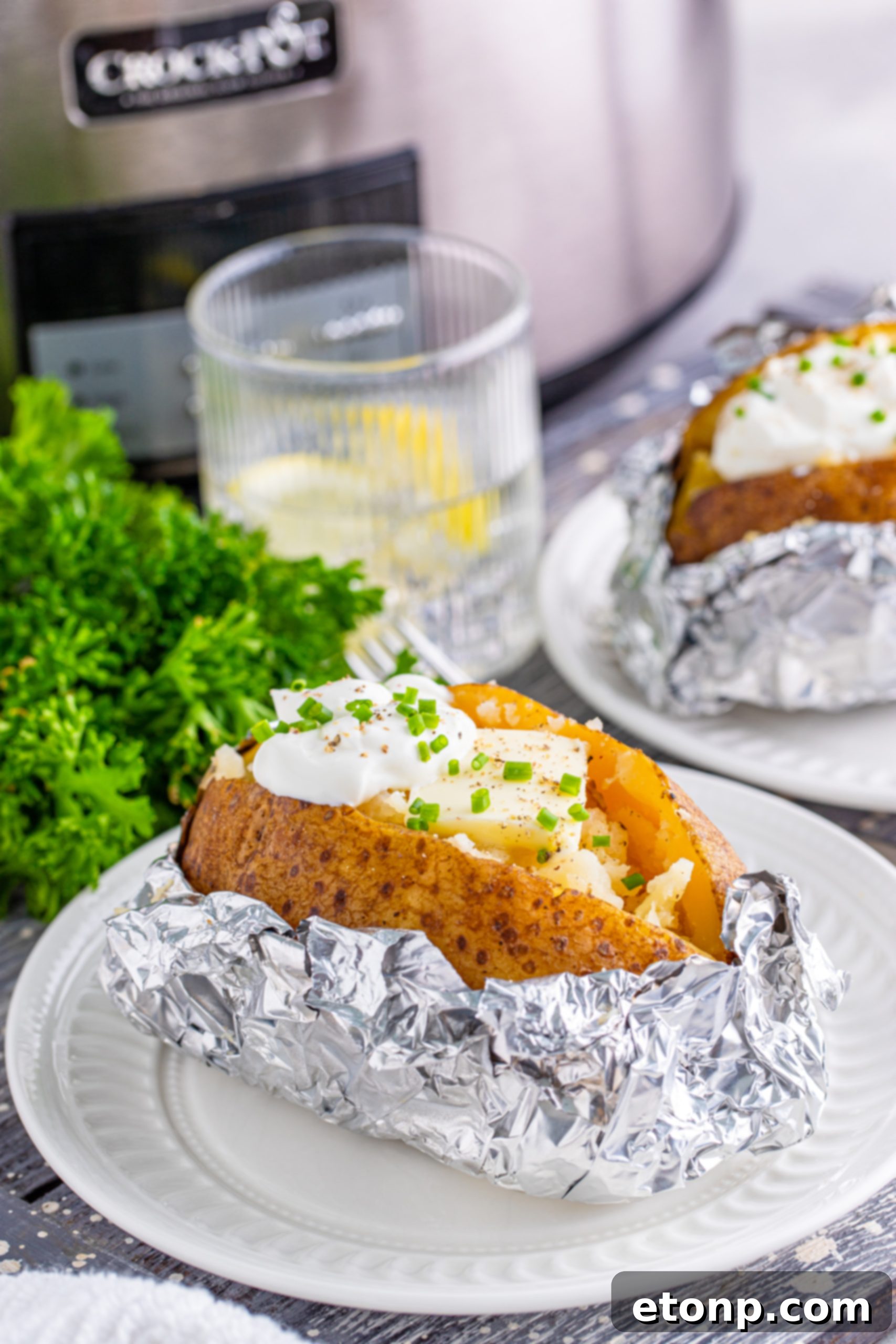 Slicing open a slow cooker baked potato to reveal fluffy interior