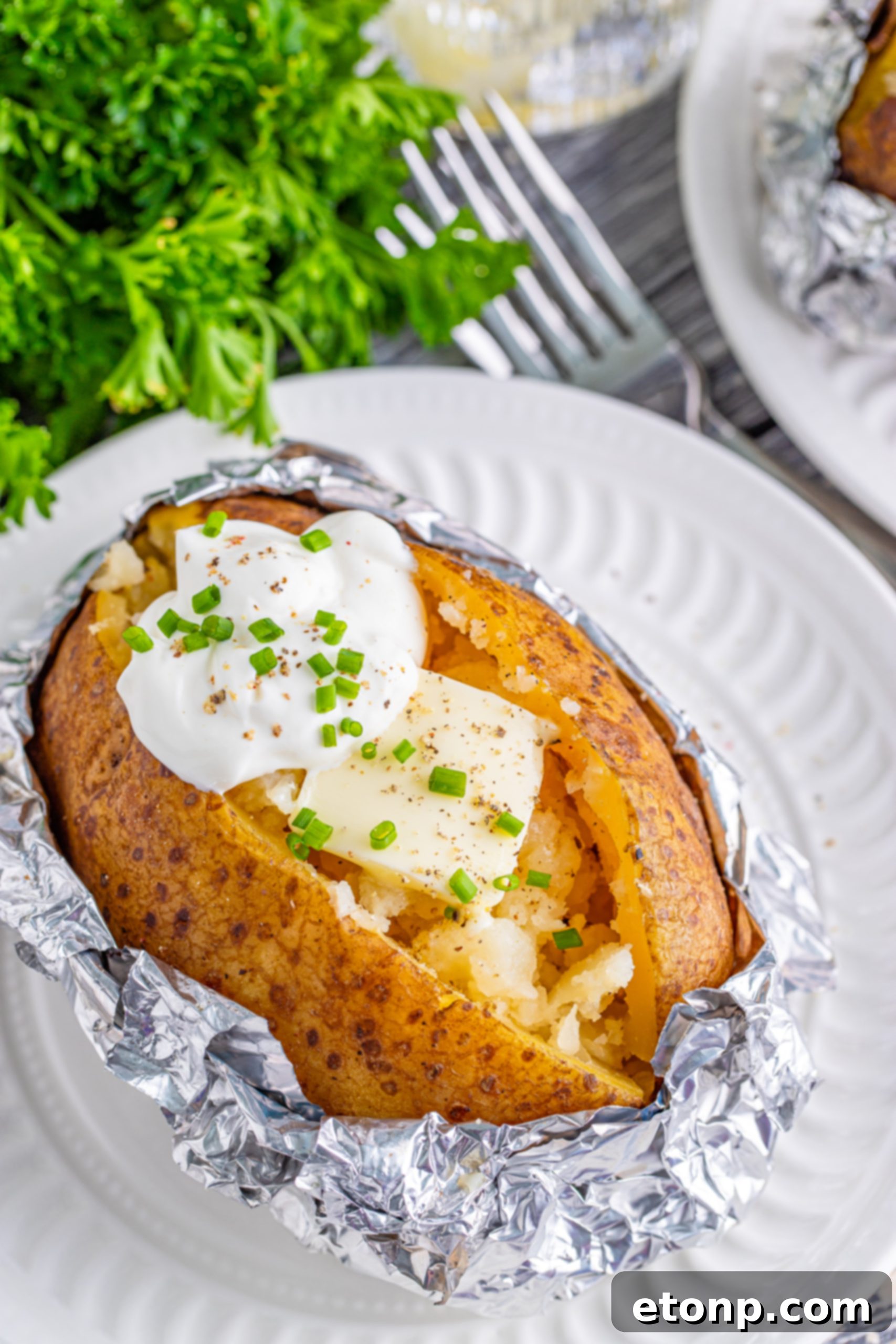 Adding butter to a freshly opened slow cooker baked potato