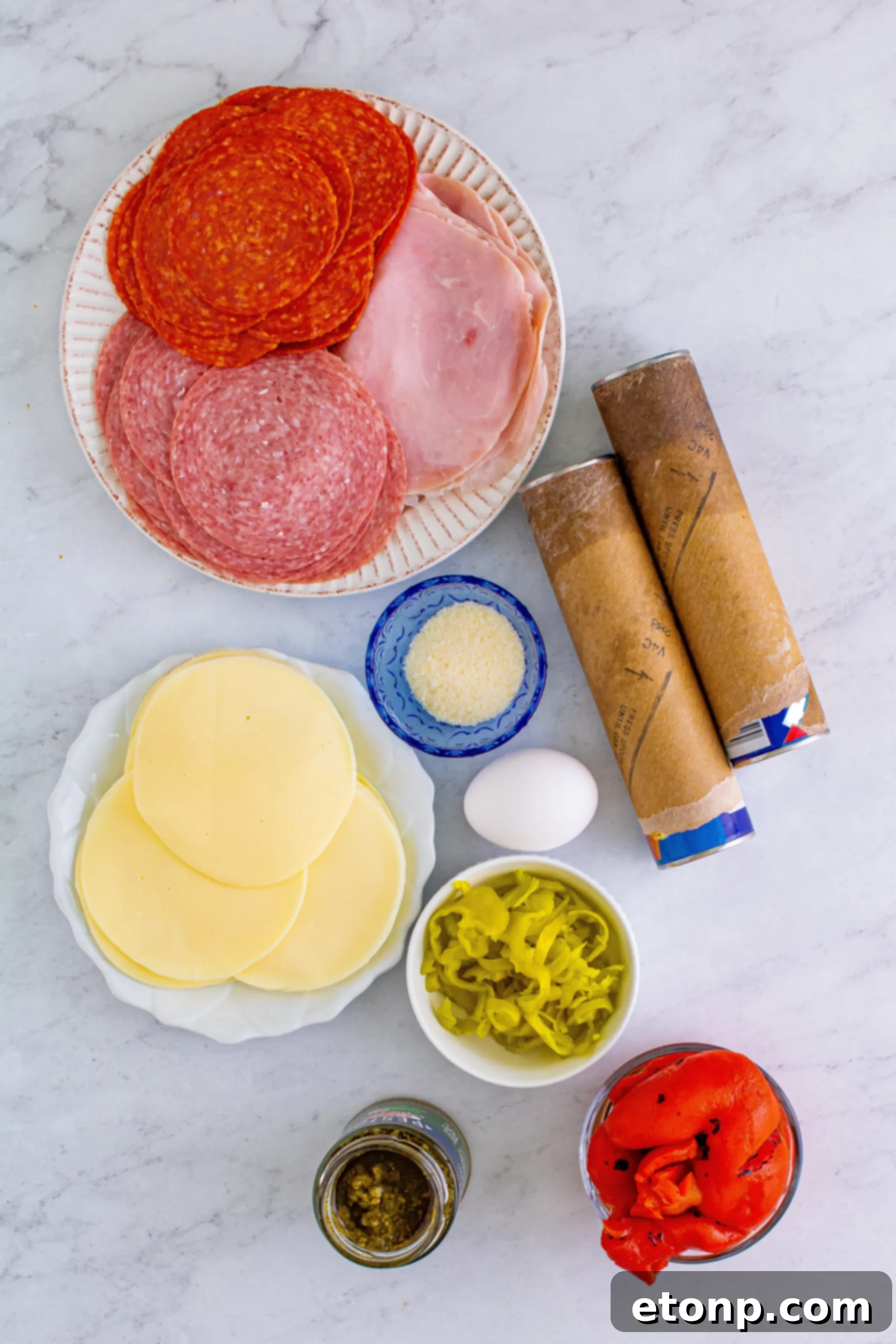 Close-up of golden-brown Italian Antipasto Squares with melted cheese and deli meats visible, ready to be served.