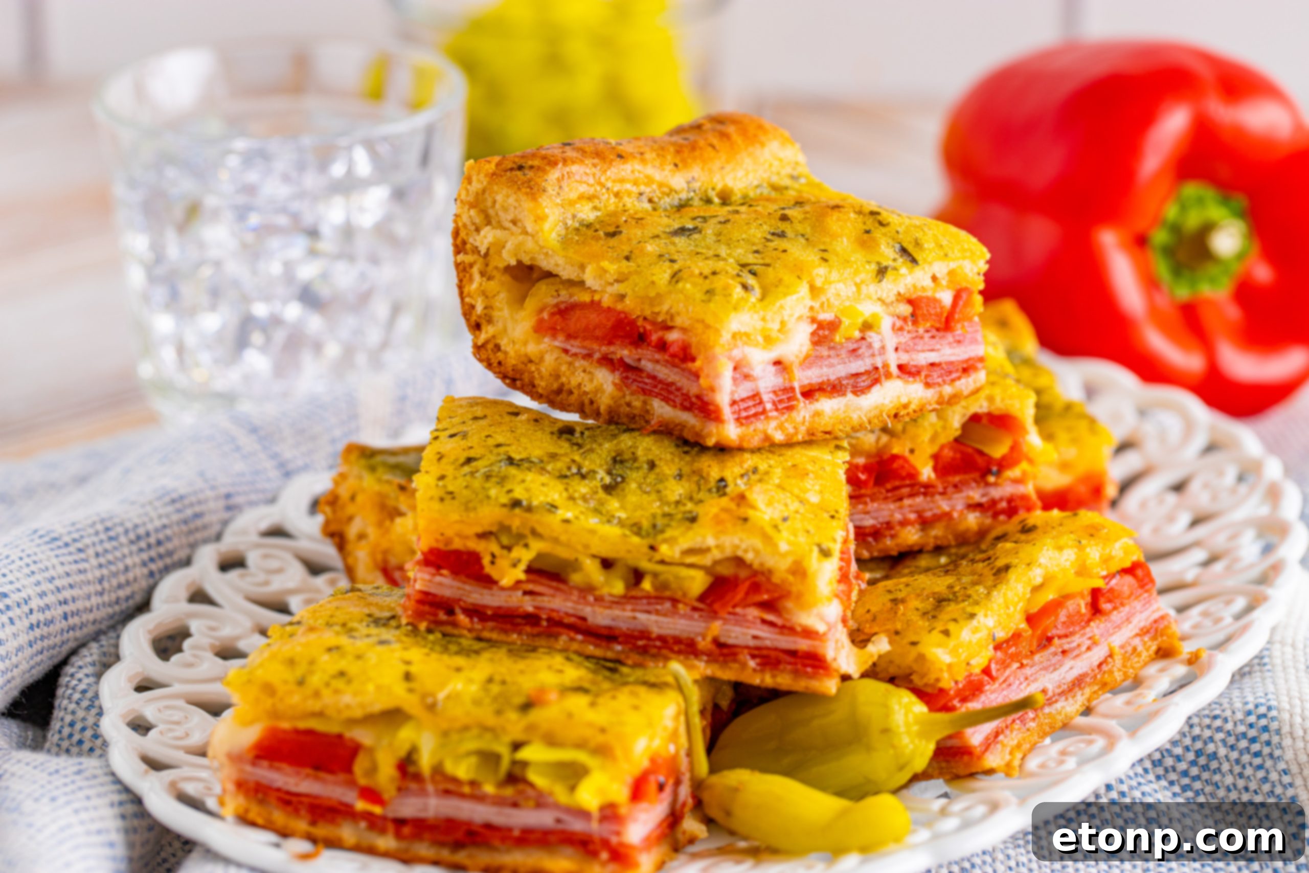 Leftover Italian Antipasto Squares stacked on a plate, ready to be stored.