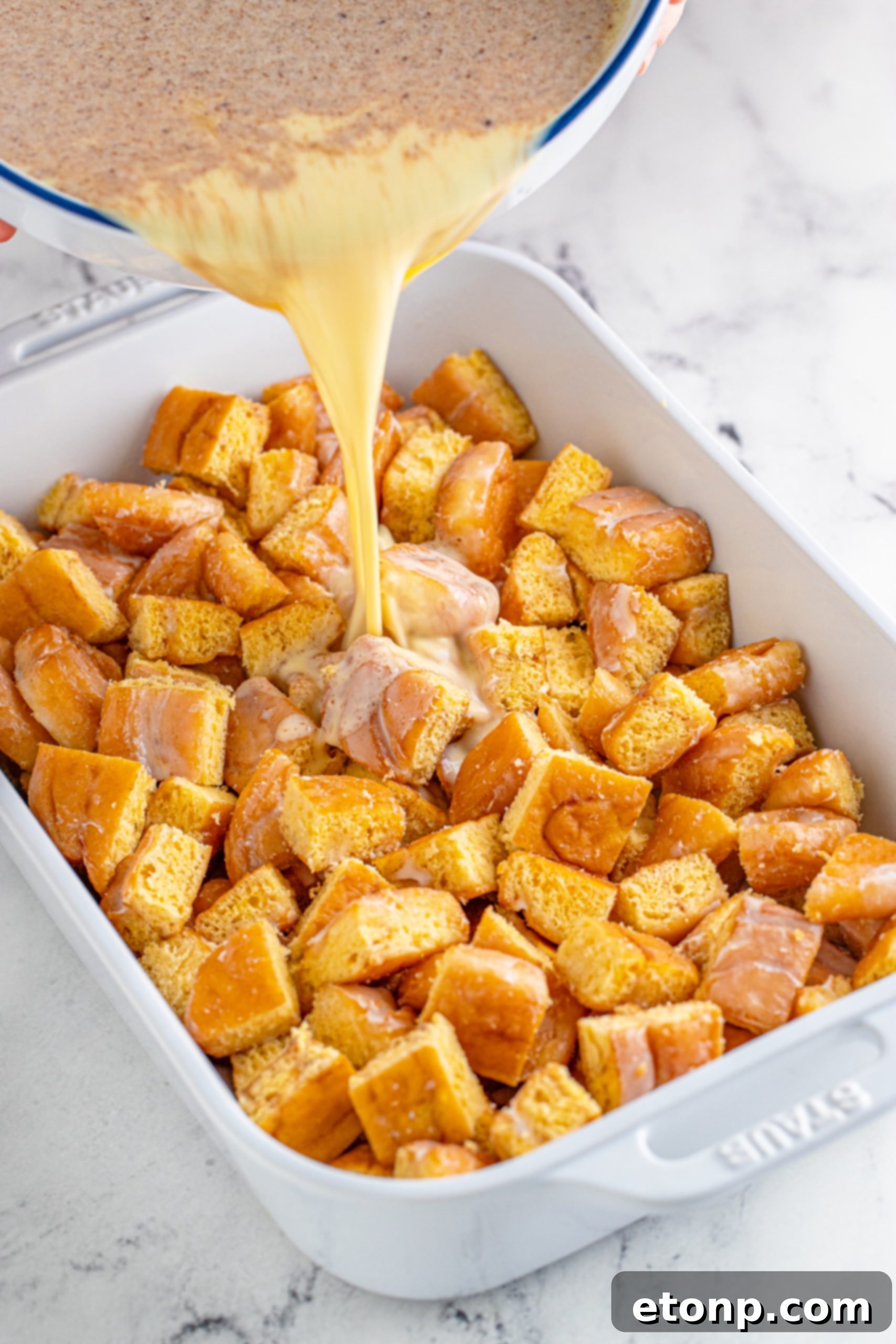 Overhead shot of honeybun bread pudding in a baking dish, ready to serve