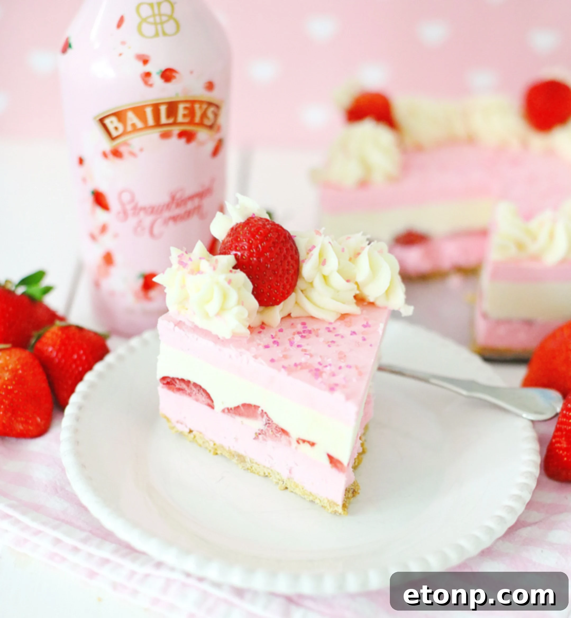 No-Bake Baileys Strawberry Cheesecake Bliss 11 A spoon scooping a portion of Baileys Strawberries & Cream Cheesecake
