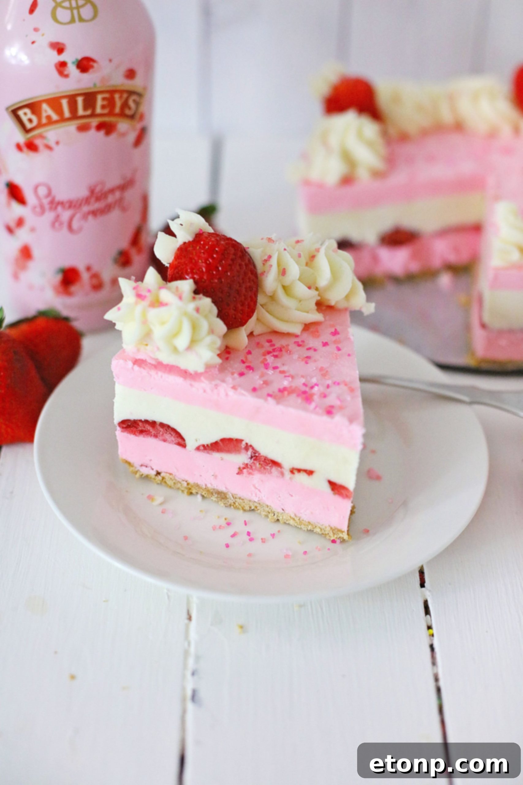 No-Bake Baileys Strawberry Cheesecake Bliss 14 Multiple slices of Baileys Strawberries & Cream Cheesecake on a serving platter