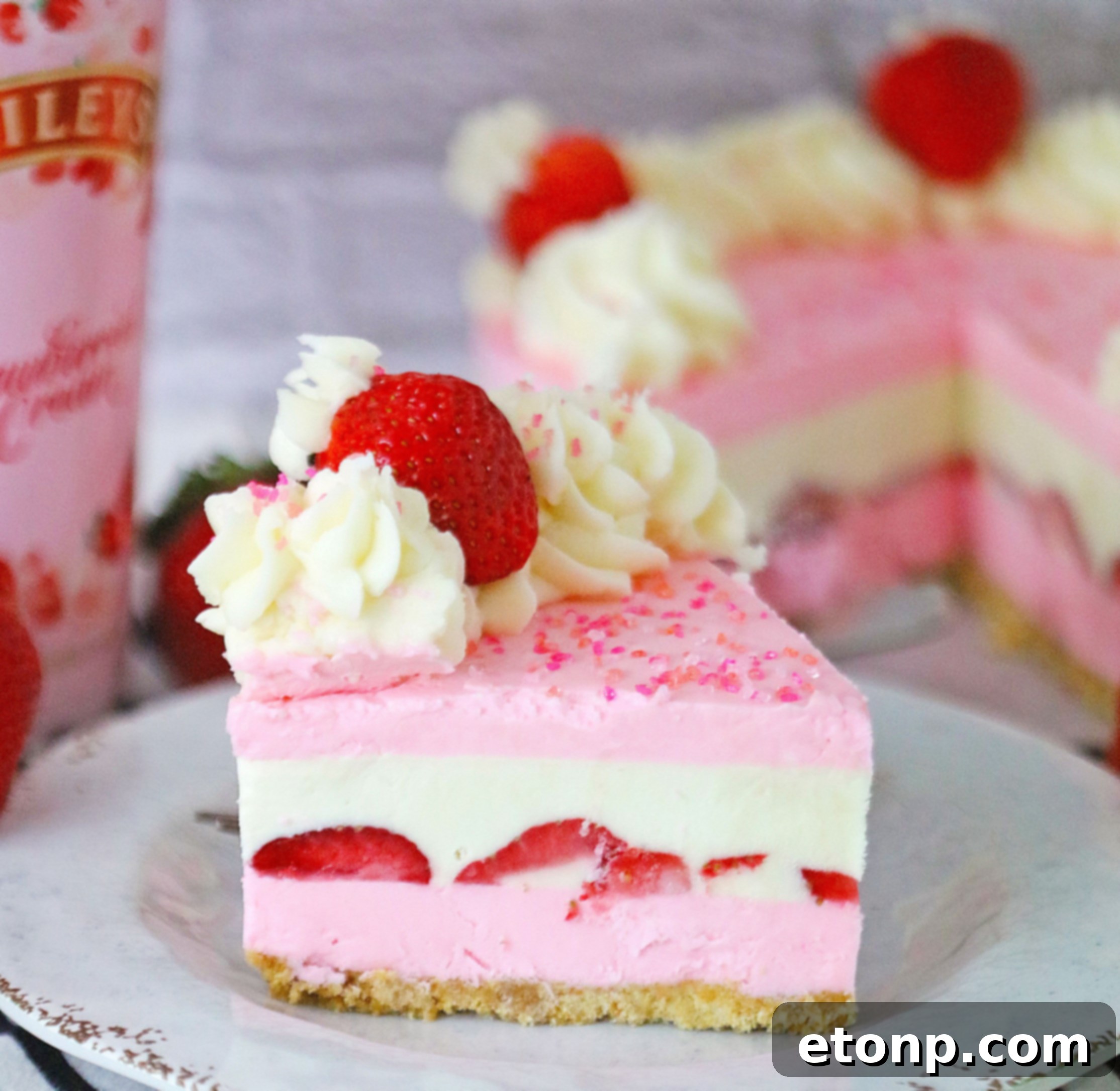 No-Bake Baileys Strawberry Cheesecake Bliss 4 Overhead view of the Baileys Strawberries & Cream Cheesecake with toppings