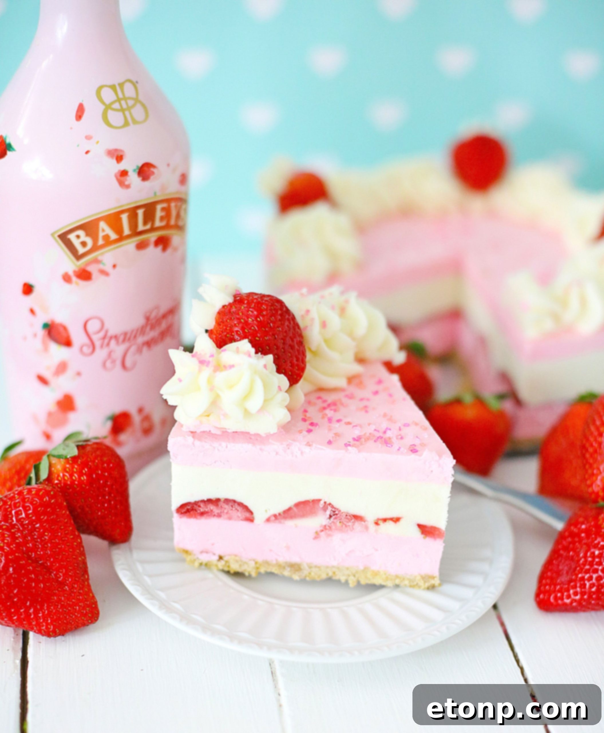 No-Bake Baileys Strawberry Cheesecake Bliss 9 A whole Baileys Strawberries & Cream Cheesecake on a stand