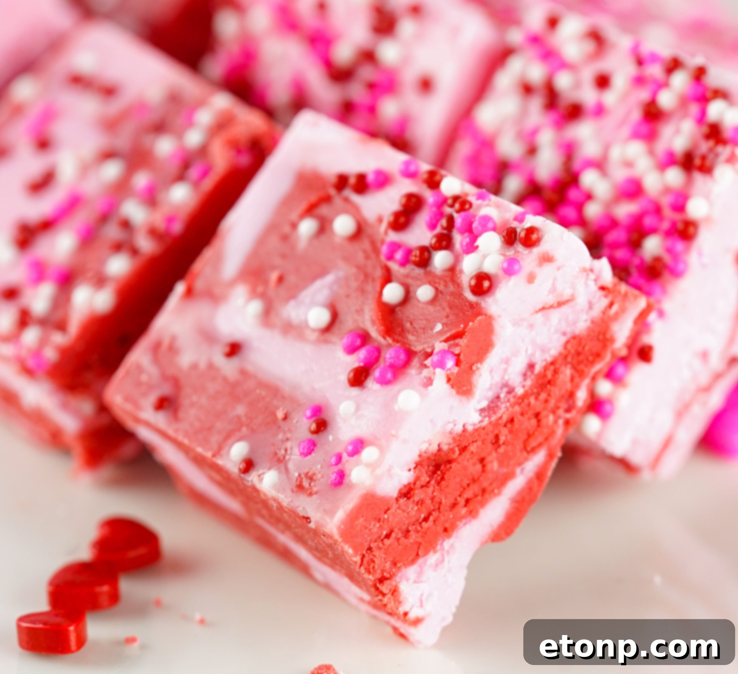 Hand holding a piece of strawberry fudge