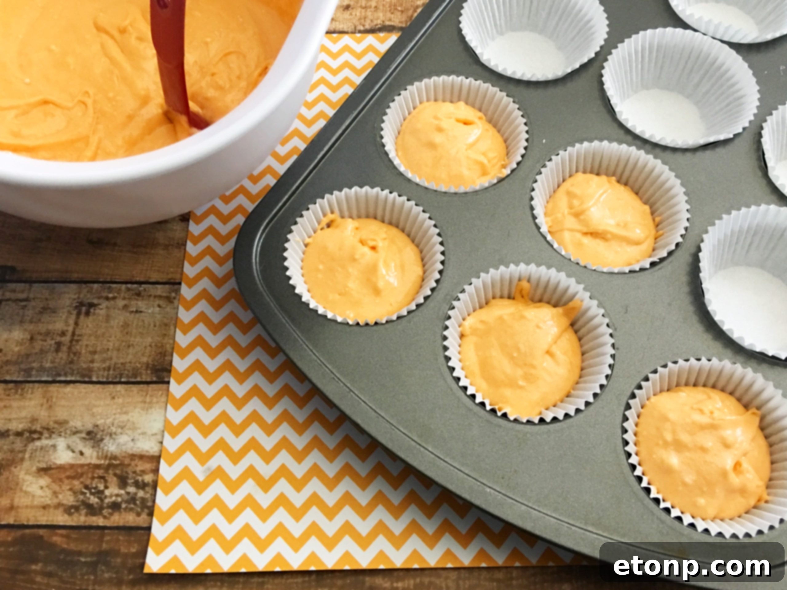 Can of Orange Crush soda positioned next to a beautifully arranged plate of Orange Creamsicle Cupcakes