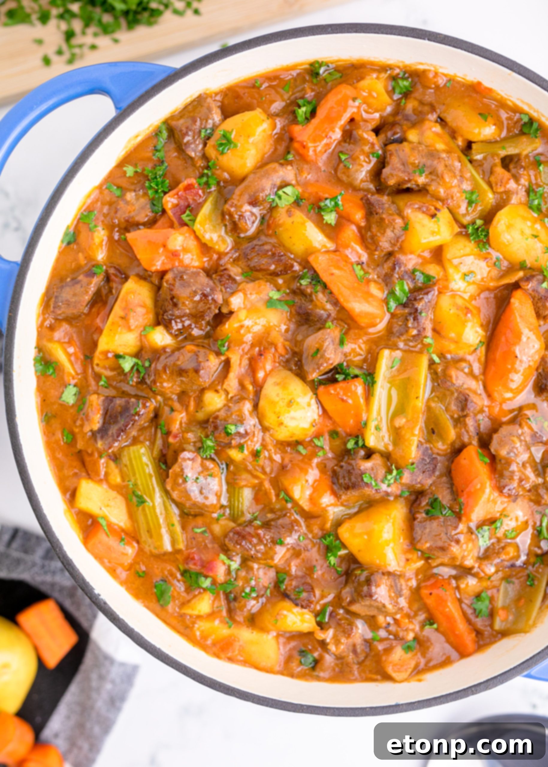 A bowl of rich, dark beef broth, an essential liquid for the stew.