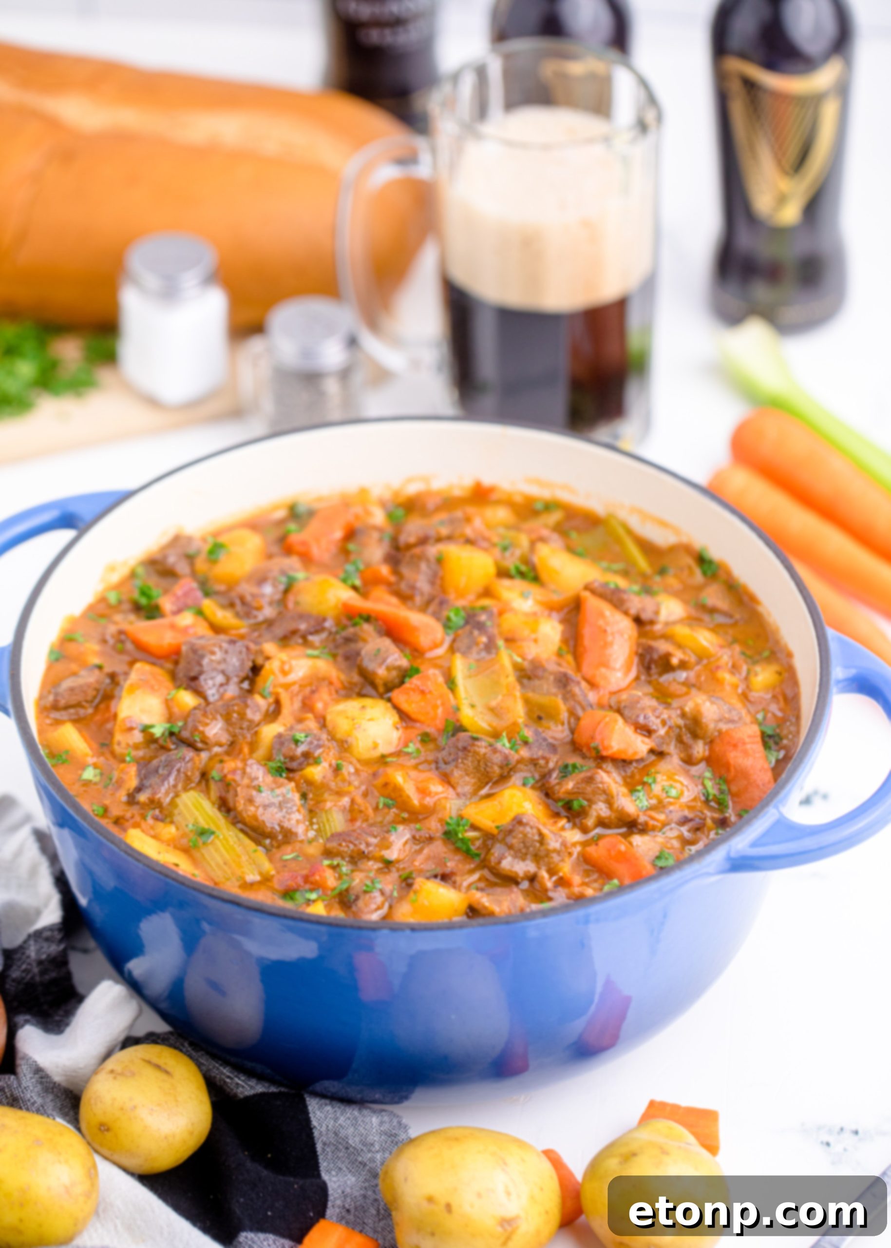 A close-up of a serving of Guinness Beef Stew with a variety of vegetables visible.