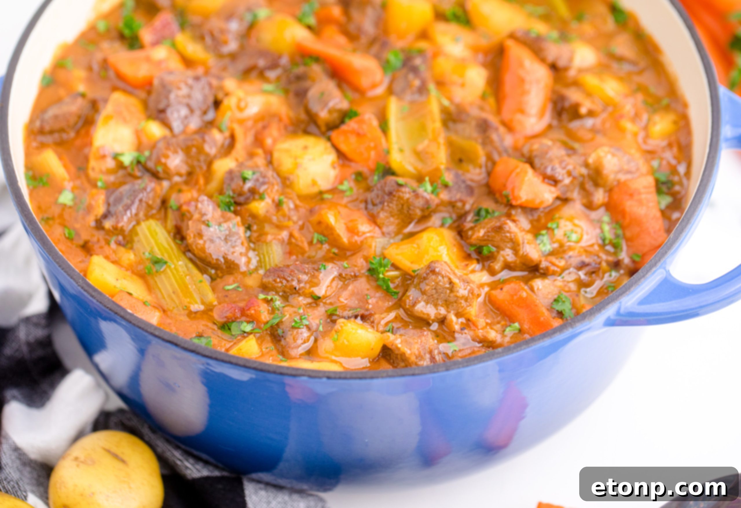 A close-up shot of Guinness Beef Stew, highlighting the rich, dark broth and chunks of tender beef.