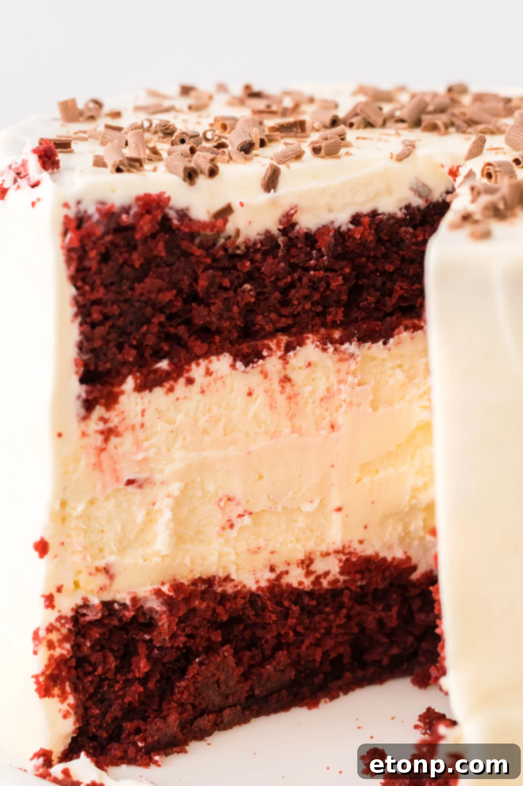 A perfectly portioned slice of Red Velvet Cheesecake Cake, showcasing its vibrant layers and creamy filling.