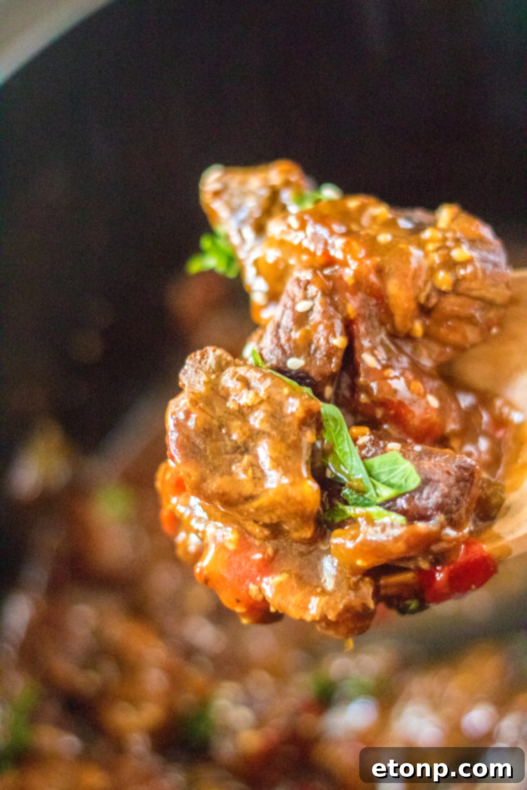Tender Slow Cooker Pepper Steak and Onions with gravy served over rice.