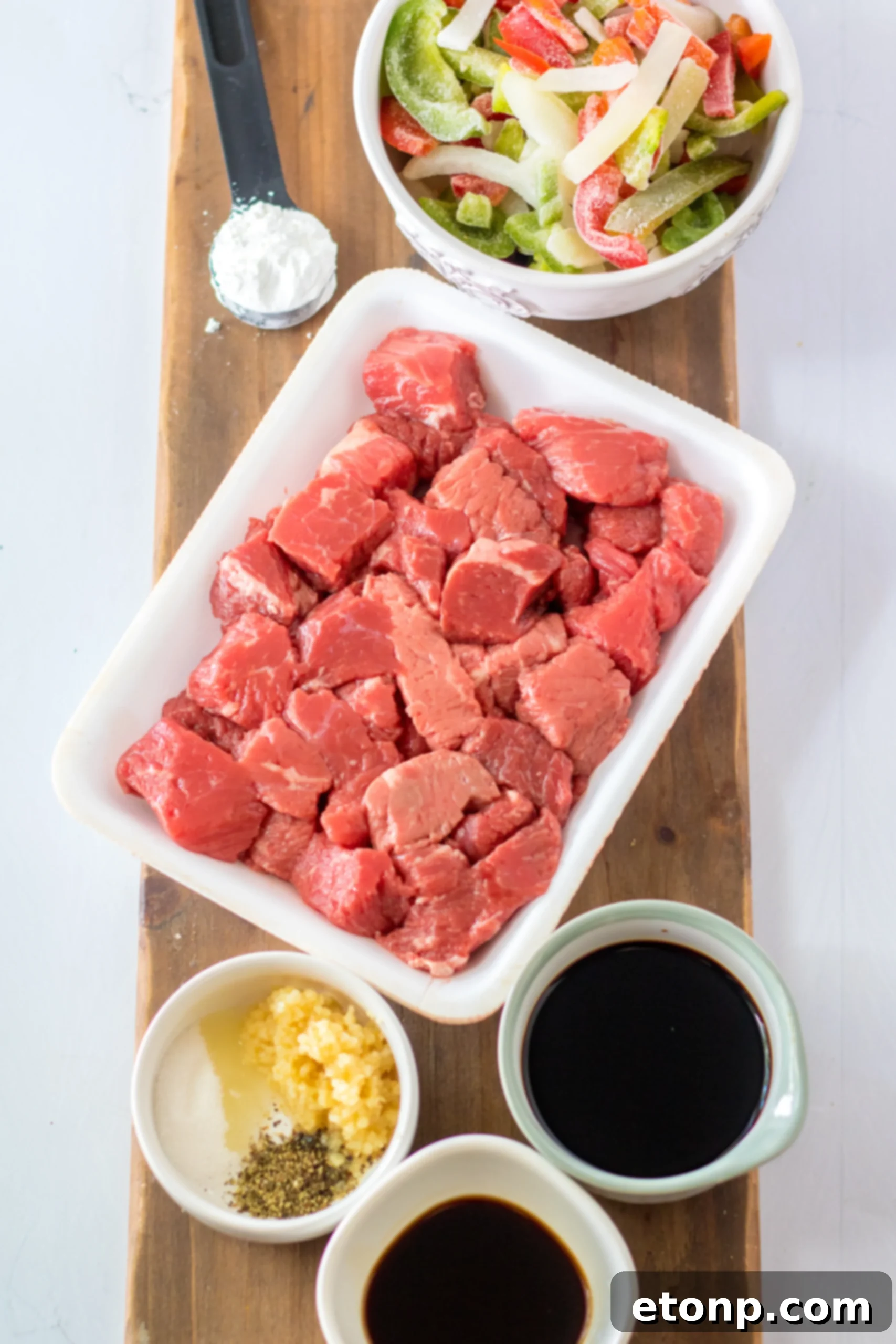 Close-up of Slow Cooker Pepper Steak in a serving bowl, showcasing tender beef and colorful peppers.