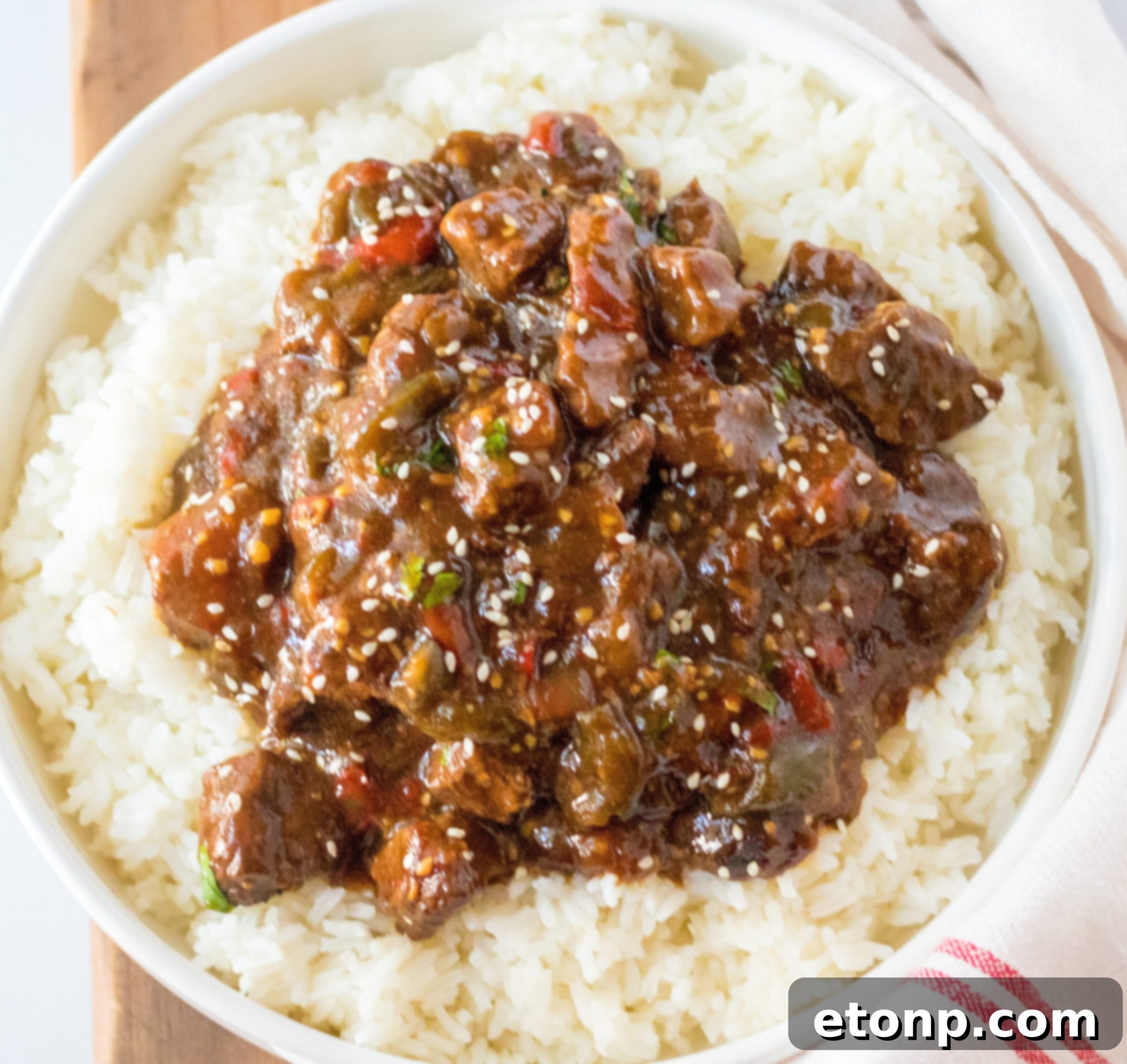 Ingredients for Slow Cooker Pepper Steak arranged on a cutting board.