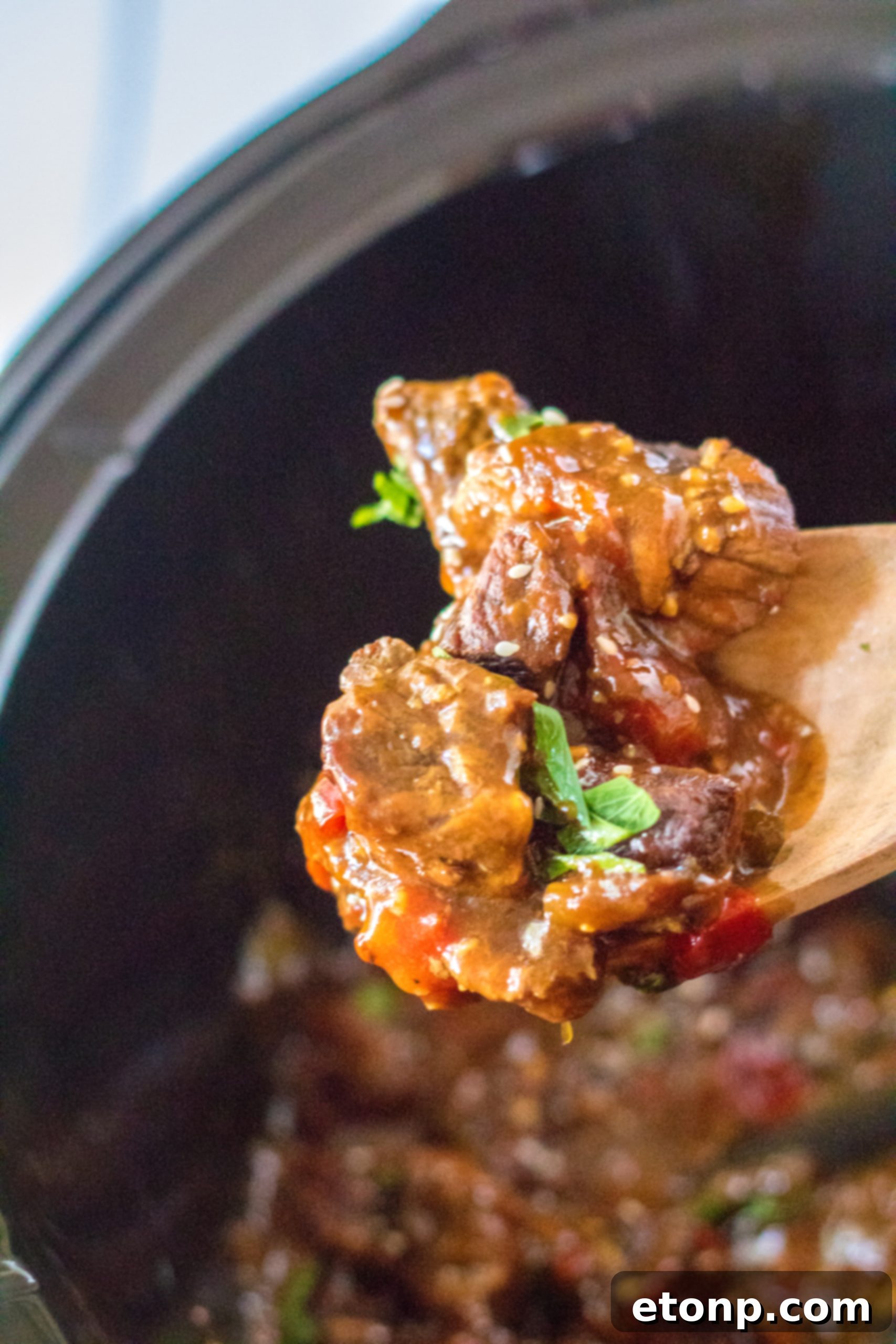 Cooked Slow Cooker Pepper Steak with rice, ready to be served.