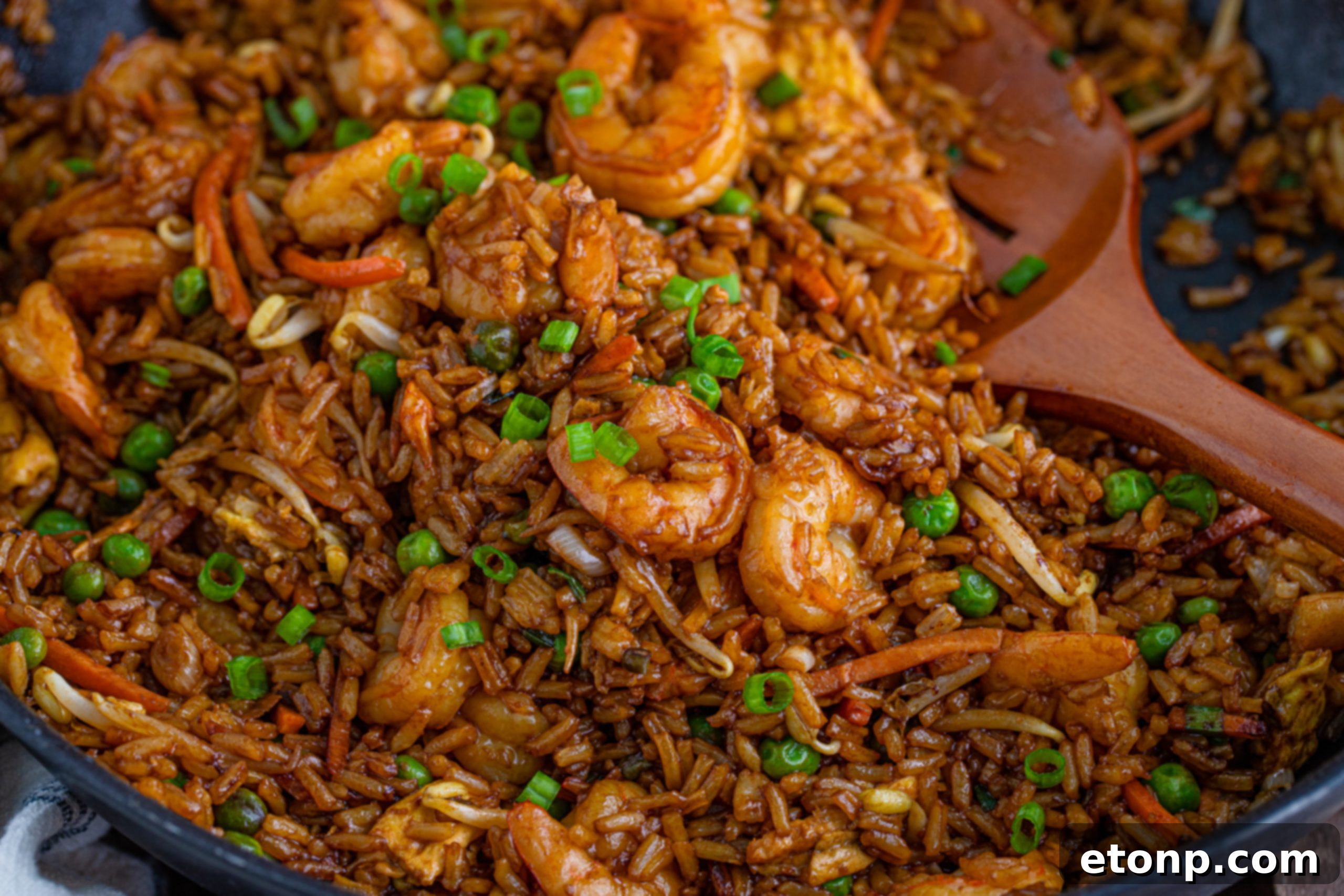 Golden Shrimp Fried Rice 19 A bowl of delicious shrimp fried rice with a pair of chopsticks.