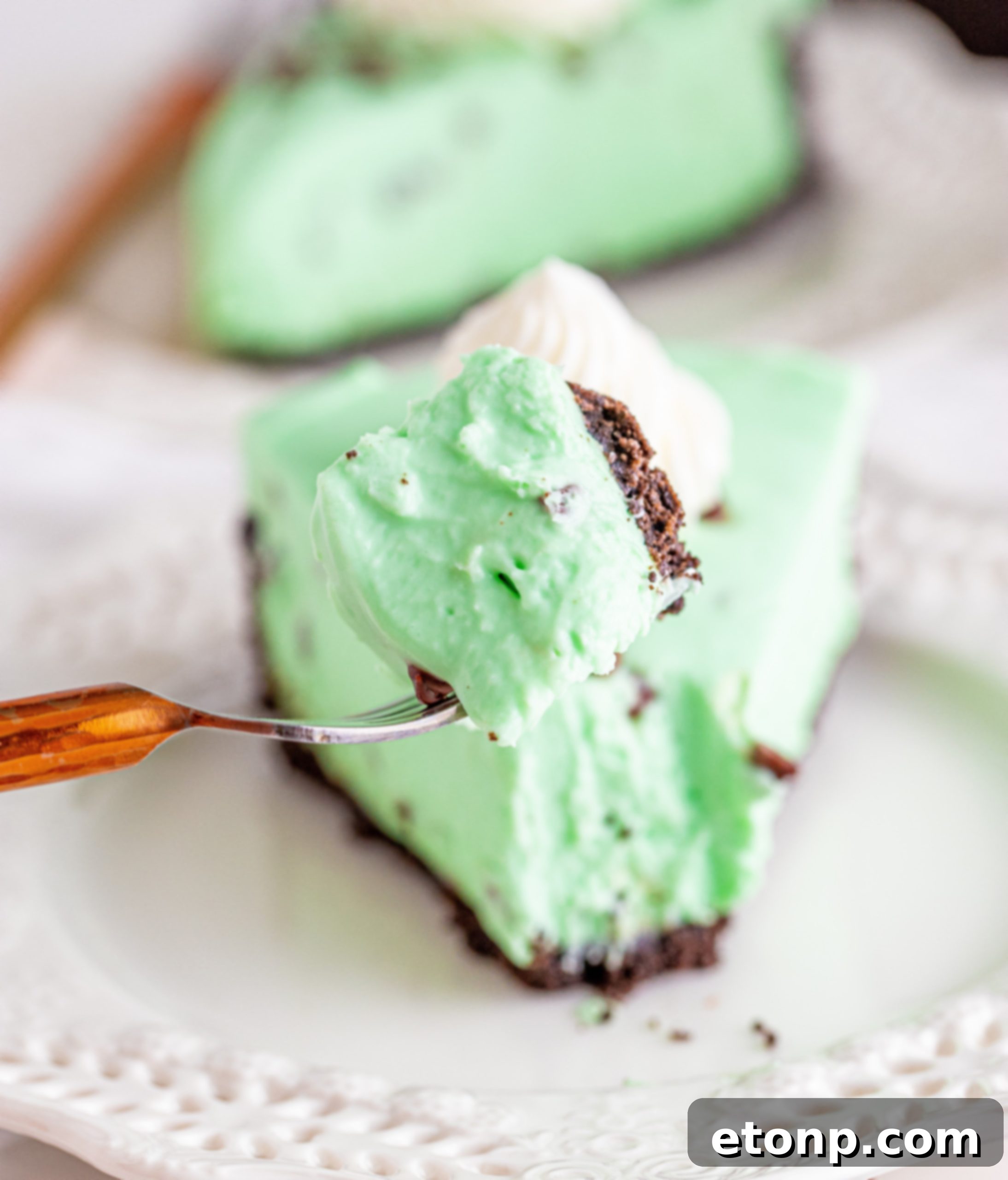 A close-up of the smooth, green cheesecake filling before being spread into the crust