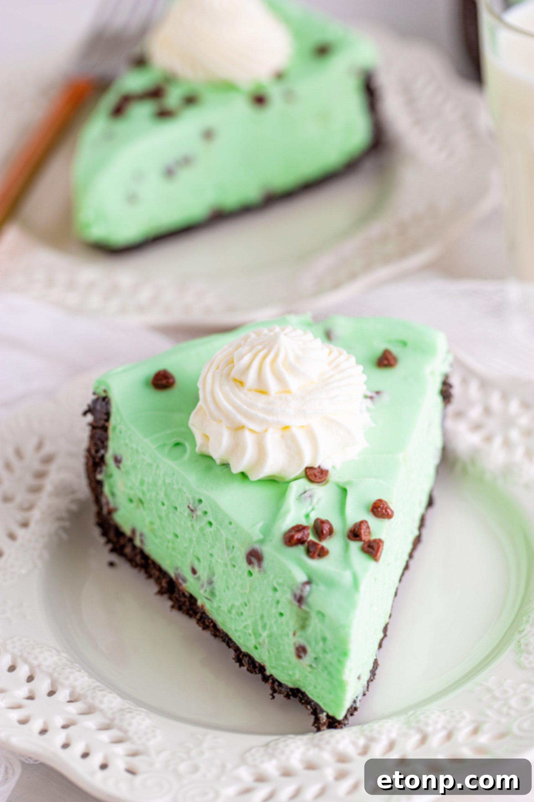 A whole no-bake mint chocolate chip cheesecake, freshly prepared and ready for chilling