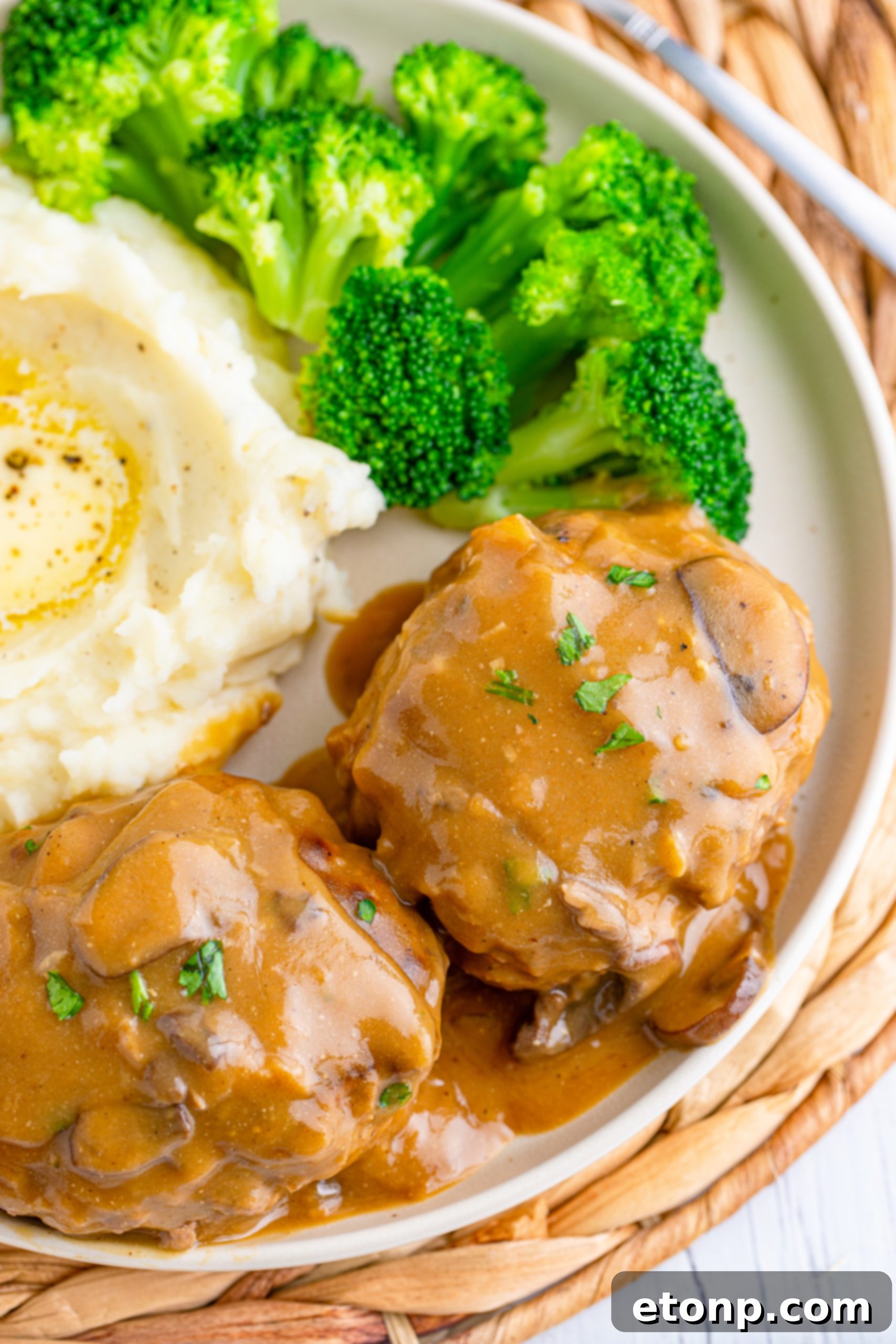 Delicious Salisbury Steak smothered in mushroom gravy with mashed potatoes