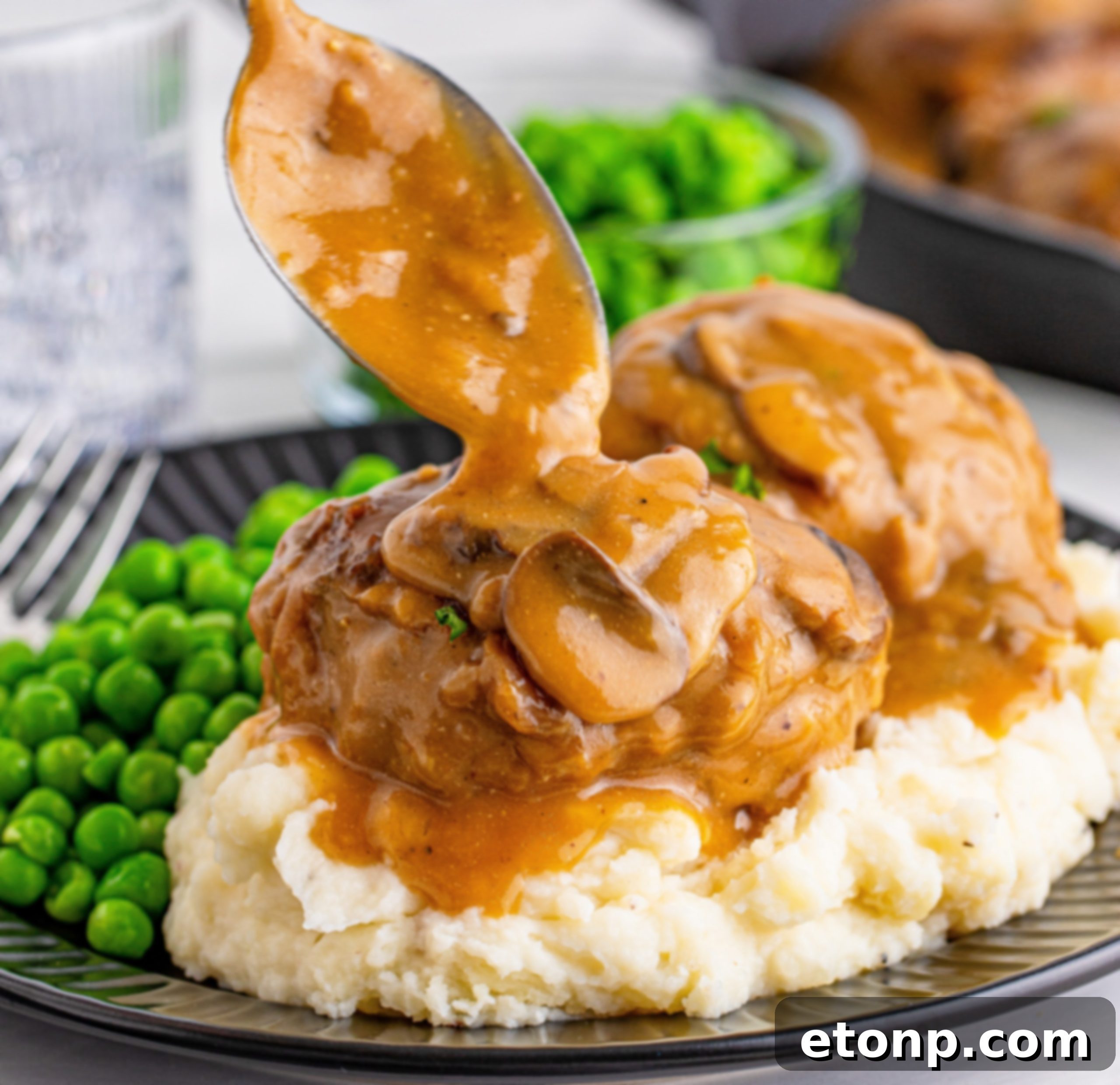 Two Salisbury Steaks with gravy on a plate