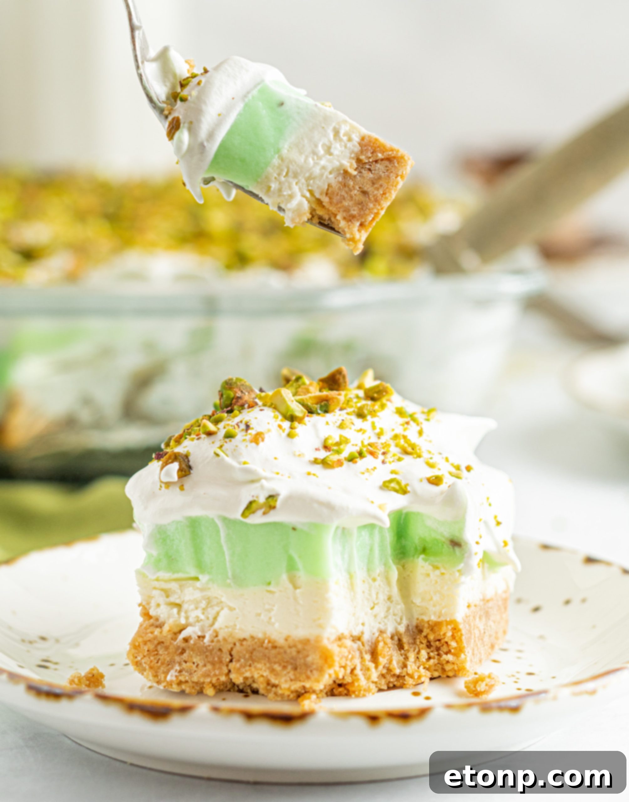 A large rectangular glass dish filled with Pistachio Lush Dessert, ready to be served or stored.