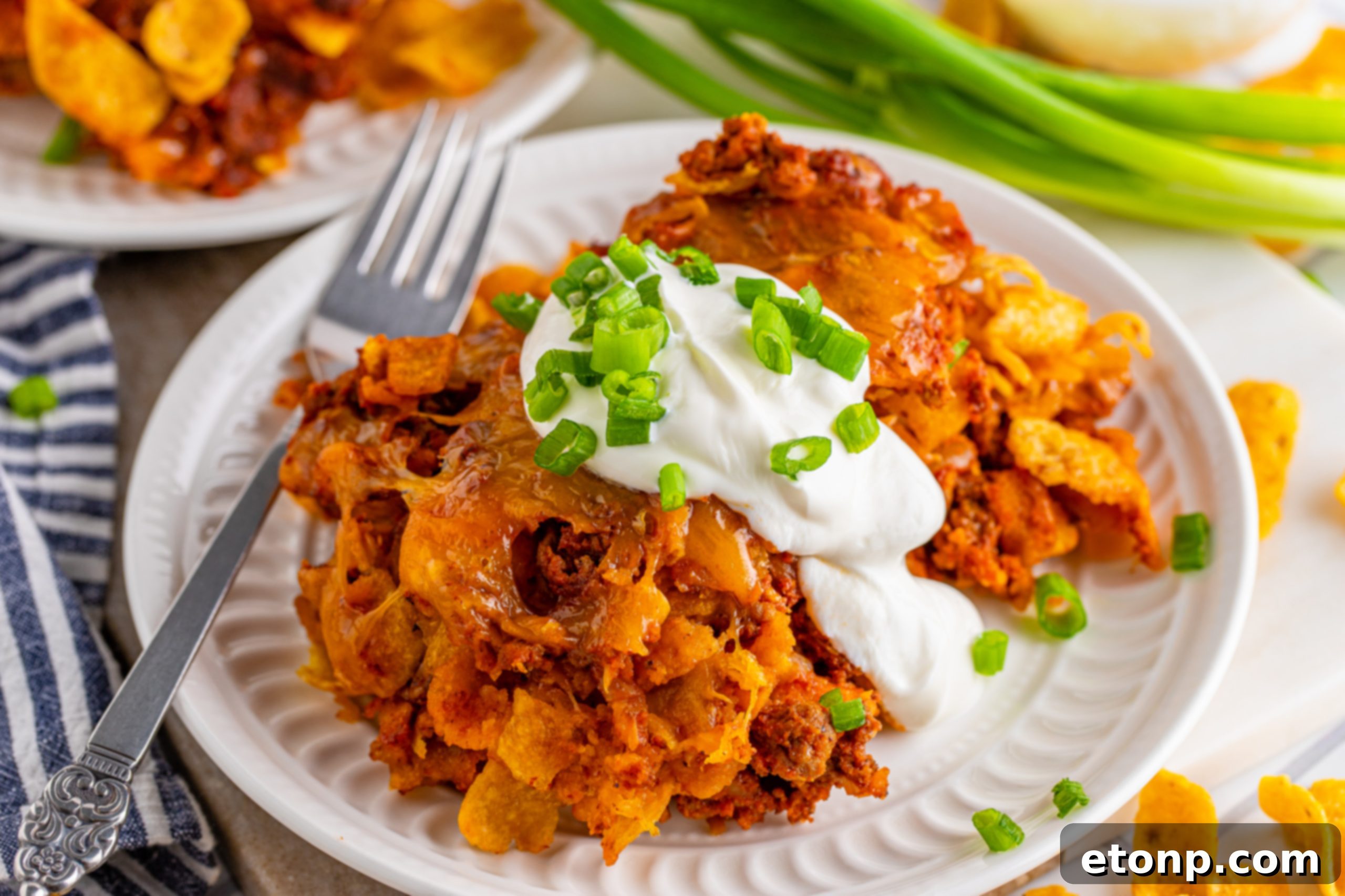 A large rectangular baking dish filled with Cheesy Frito Chili Casserole