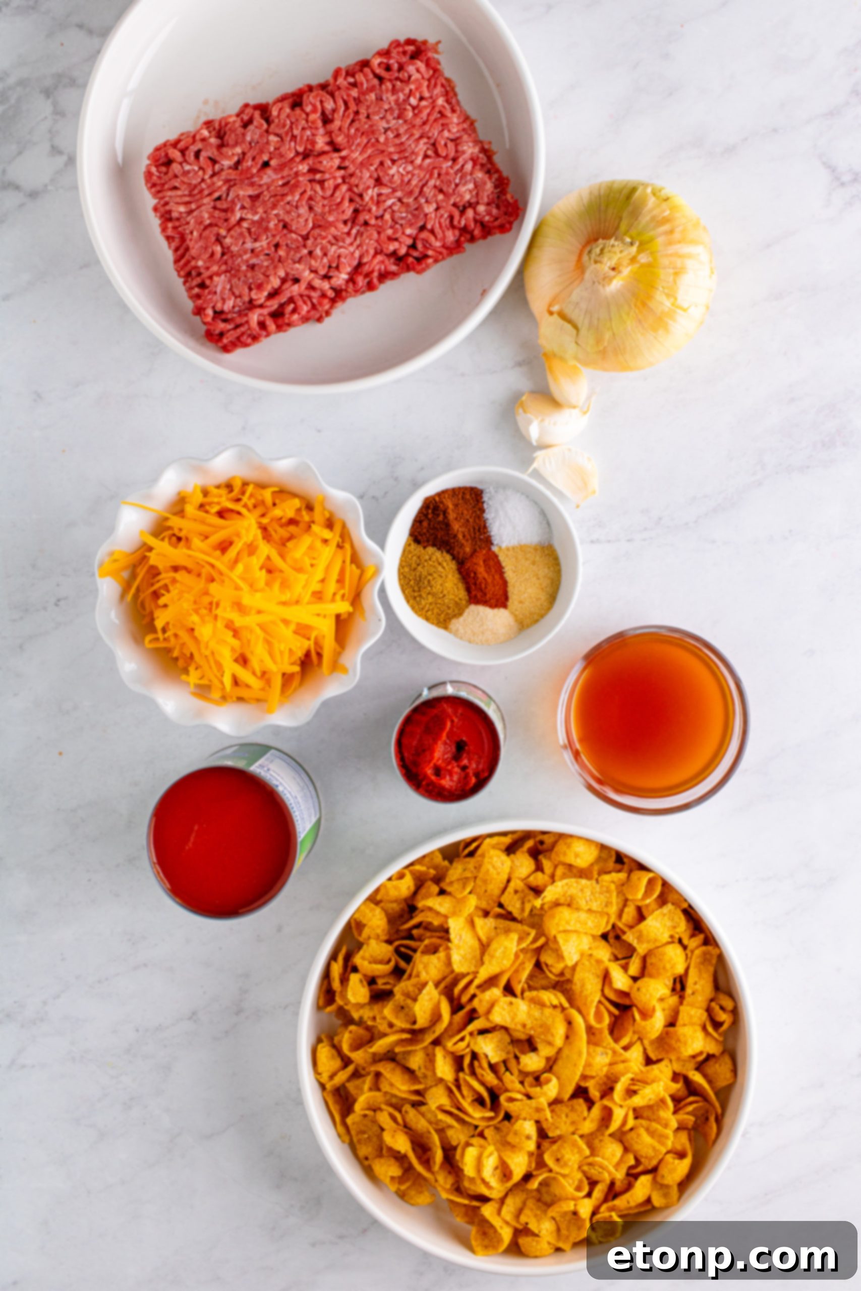 Top-down view of Cheesy Frito Chili Casserole in a baking dish