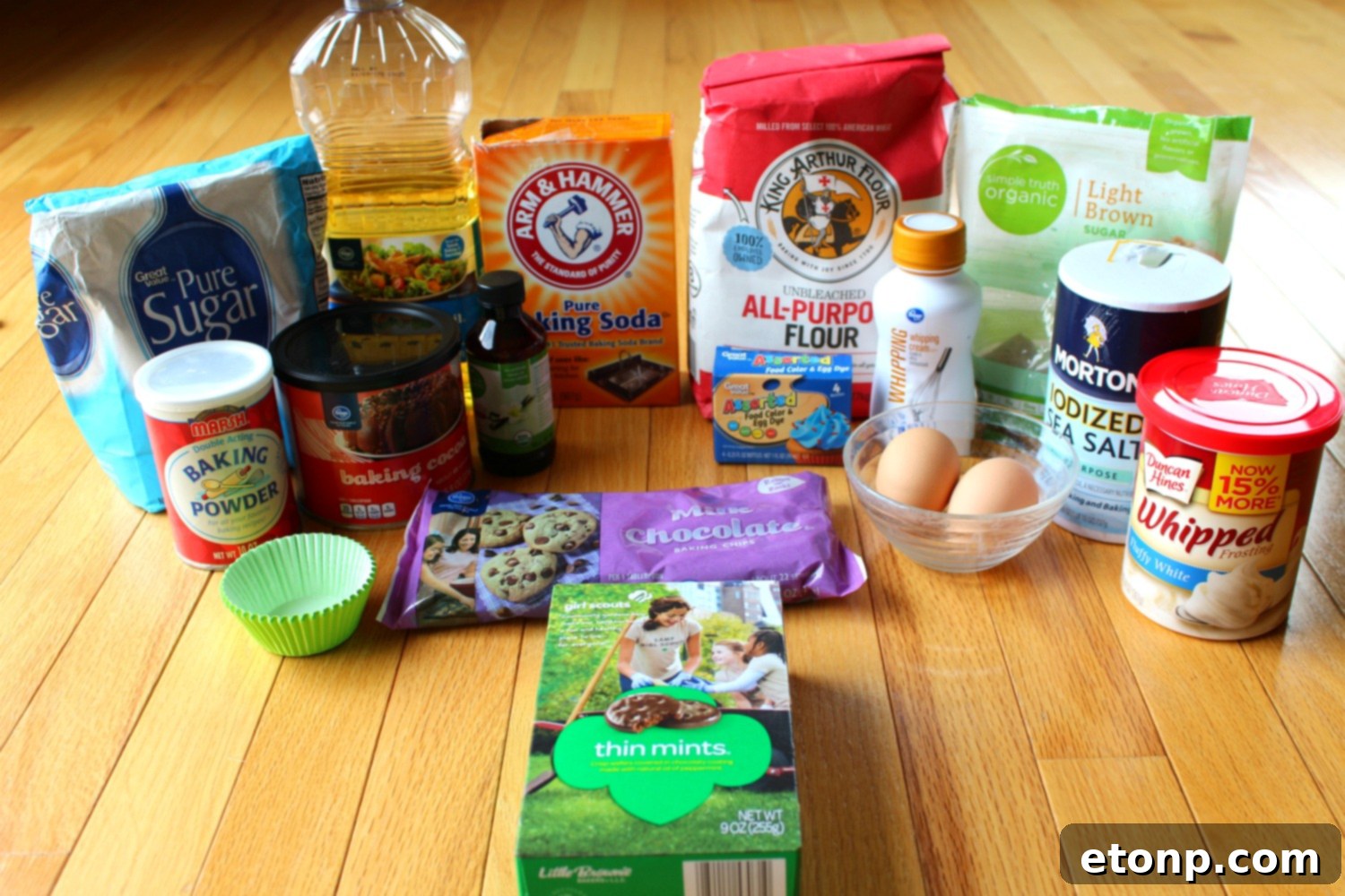 A vibrant selection of cupcake ingredients laid out on a clean kitchen counter, ready for baking.