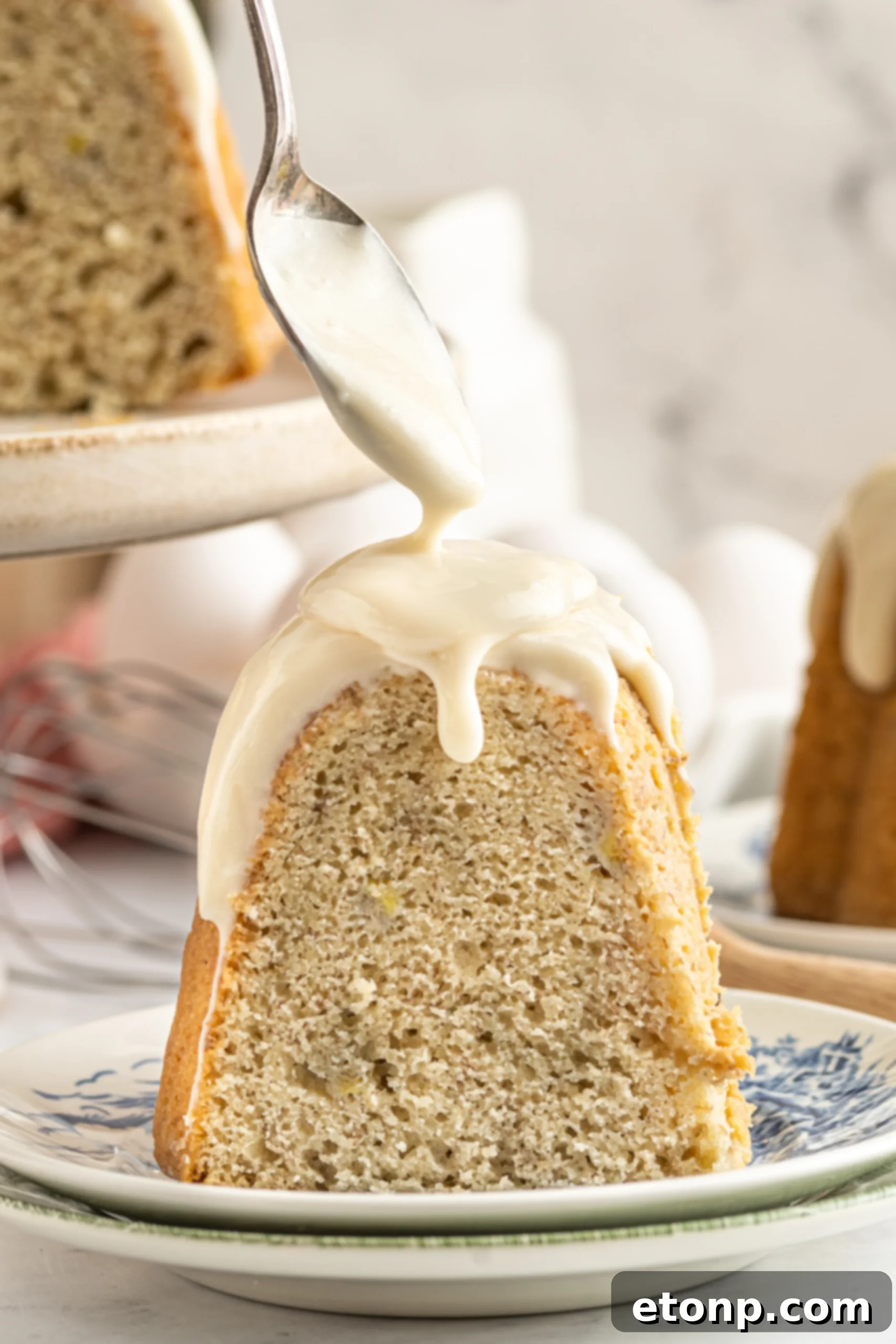 Pouring icing on a banana cake on a plate