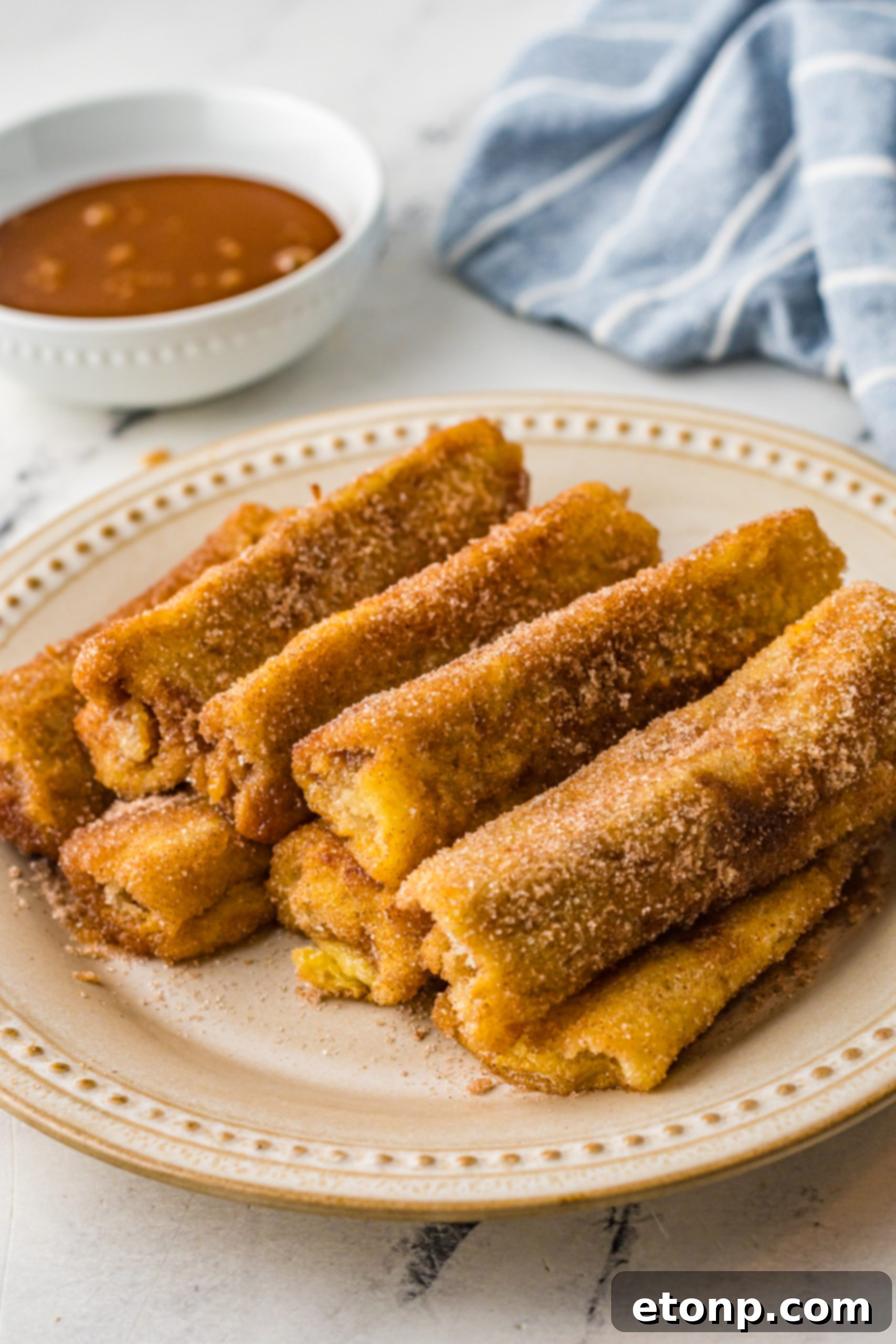 Churro French Toast Roll Ups on a wire rack