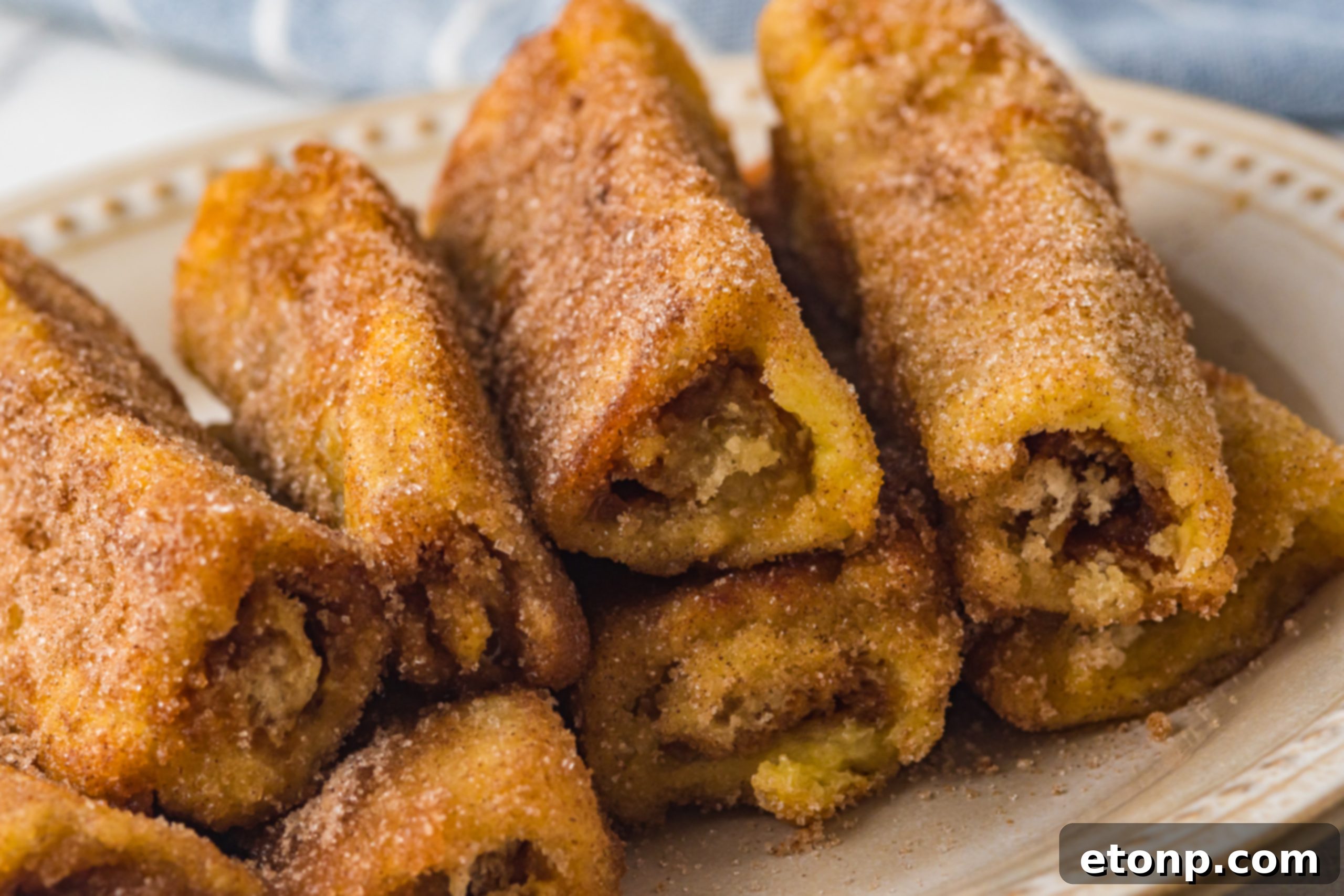 Cooked Churro French Toast Roll Ups on a cooling rack