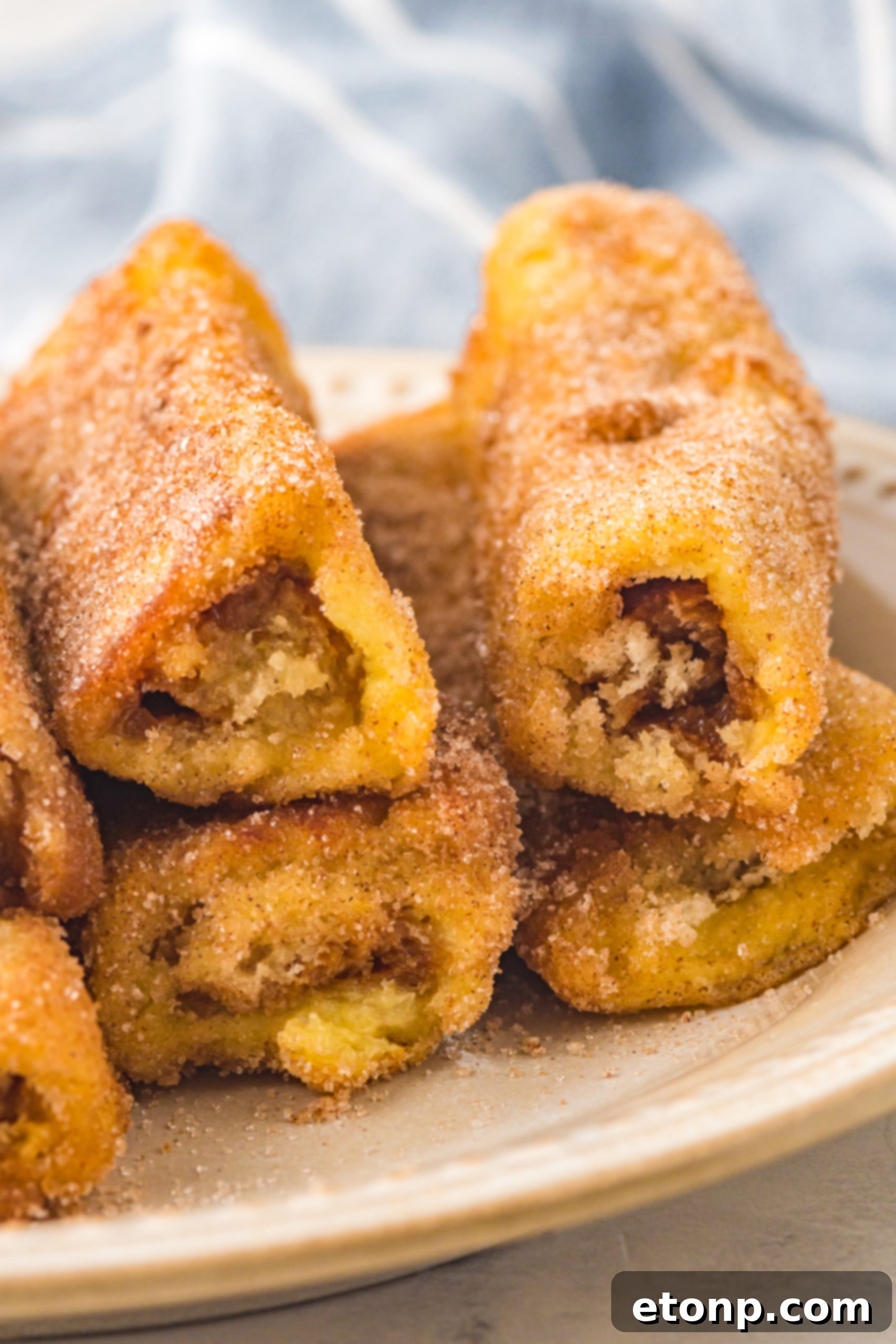 Churro French Toast Roll Ups on a wooden board