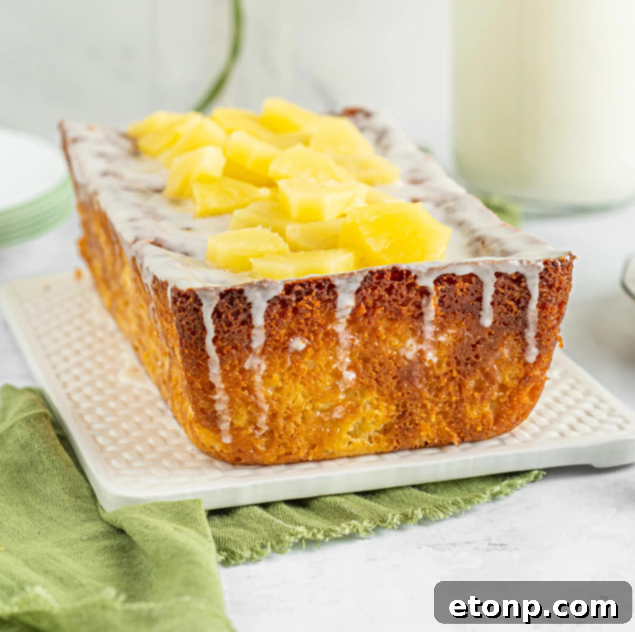 Glazed pineapple loaf cake on a serving plate
