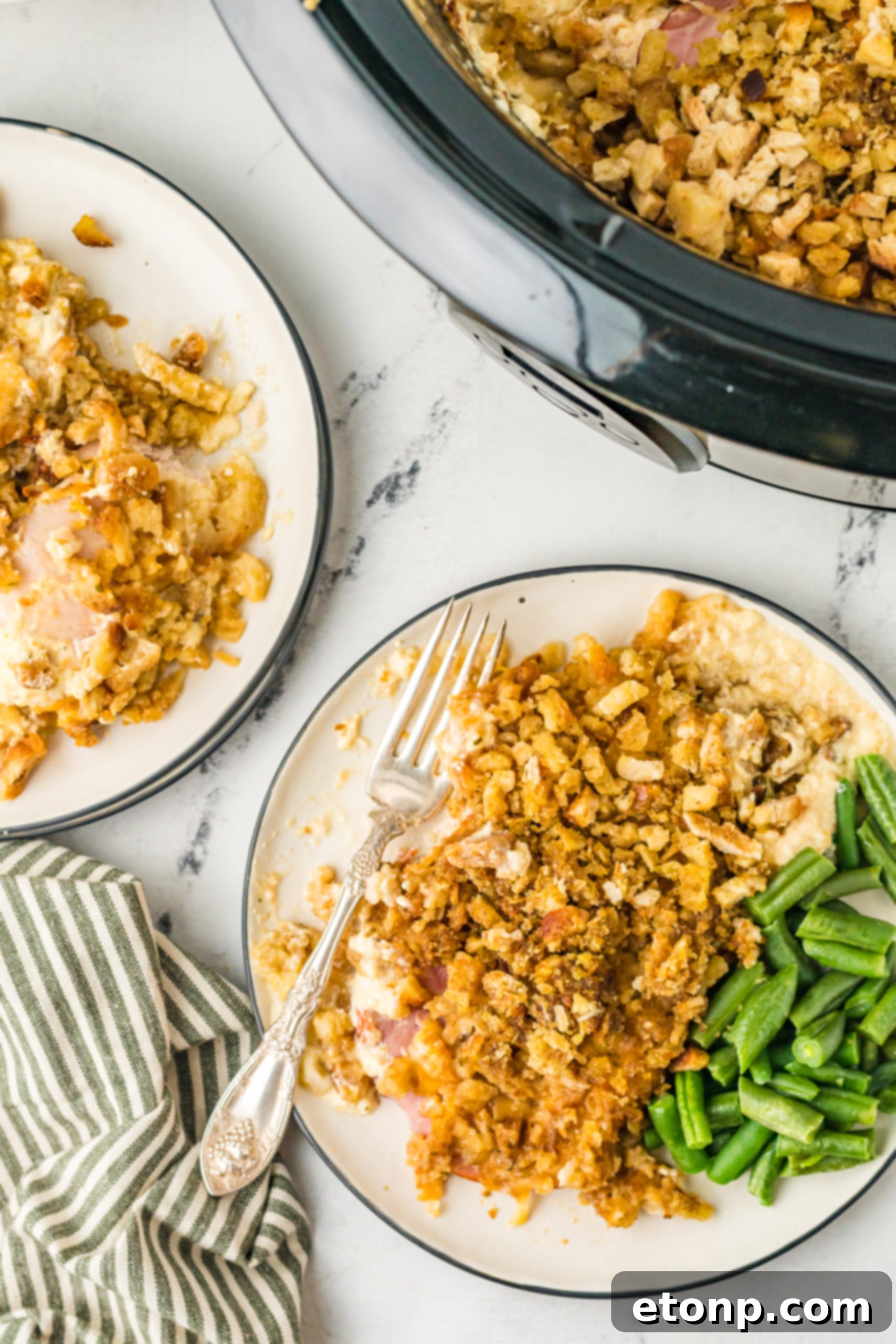 Slow Cooker Chicken Cordon Bleu with Savory Stuffing 4 Overhead shot of Slow Cooker Chicken Cordon Bleu with a serving spoon, highlighting the layers.