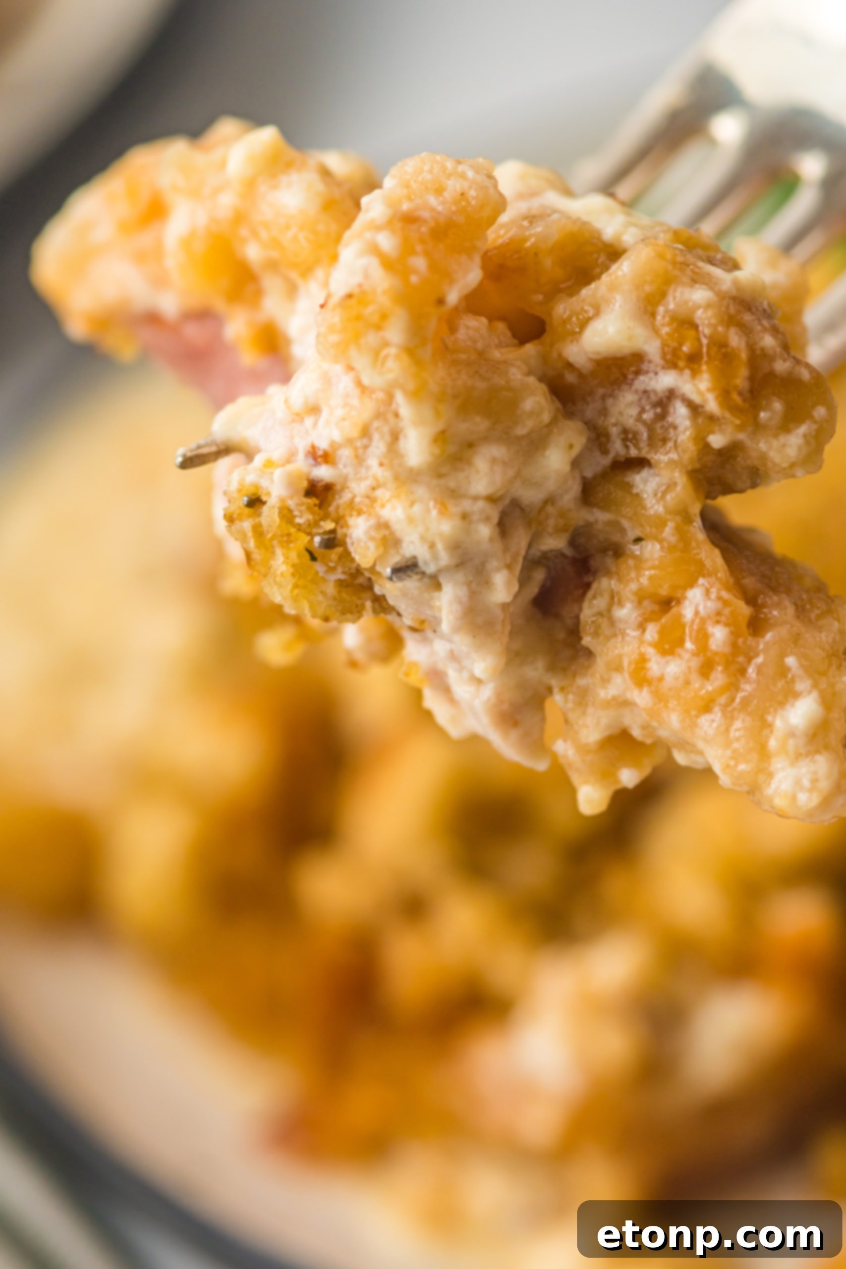 Slow Cooker Chicken Cordon Bleu with Savory Stuffing 6 A close-up of the Slow Cooker Chicken Cordon Bleu in the crockpot, showing the golden stuffing topping.
