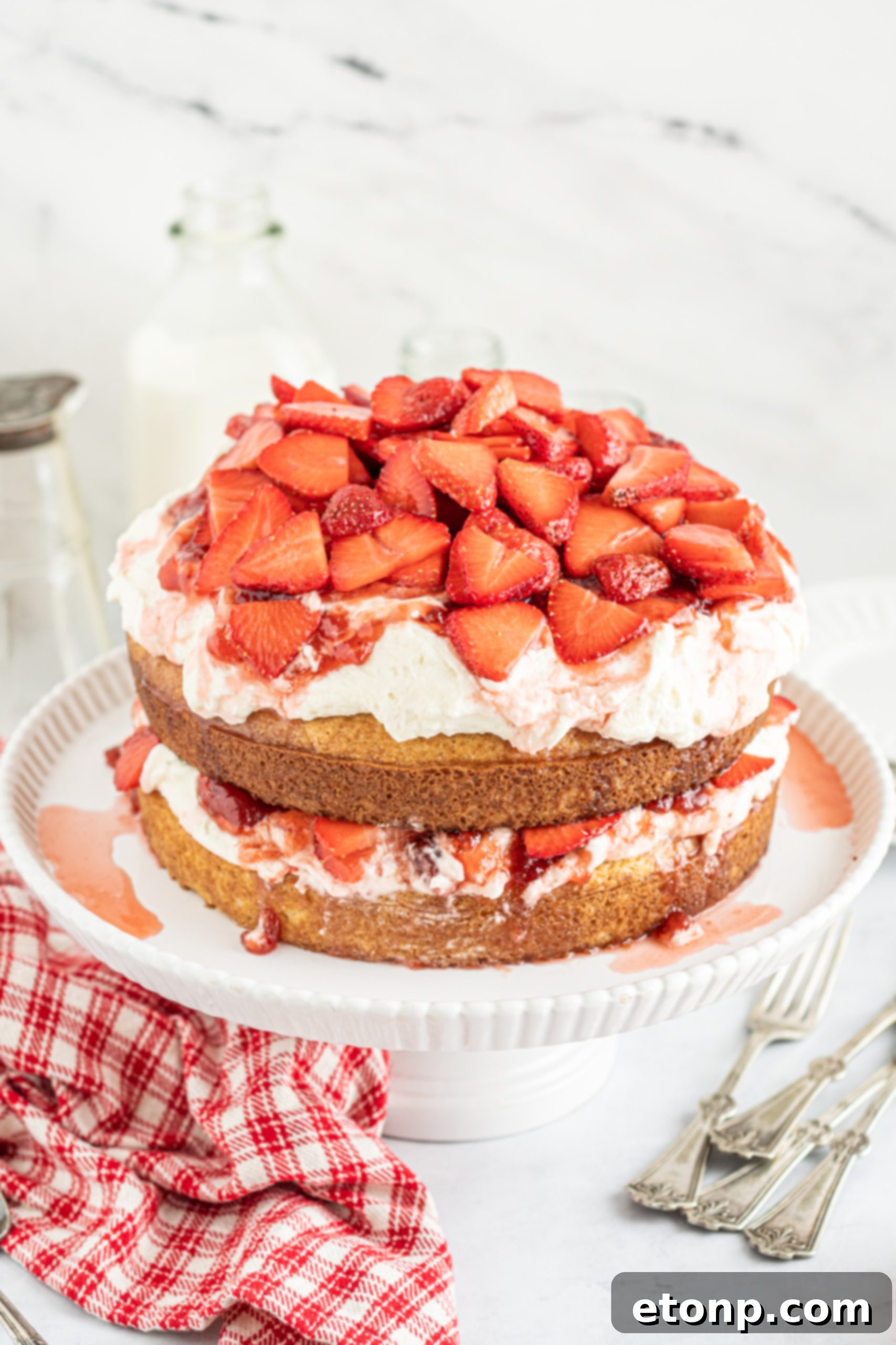 Freshly sliced strawberries, ready to be added to the cake.
