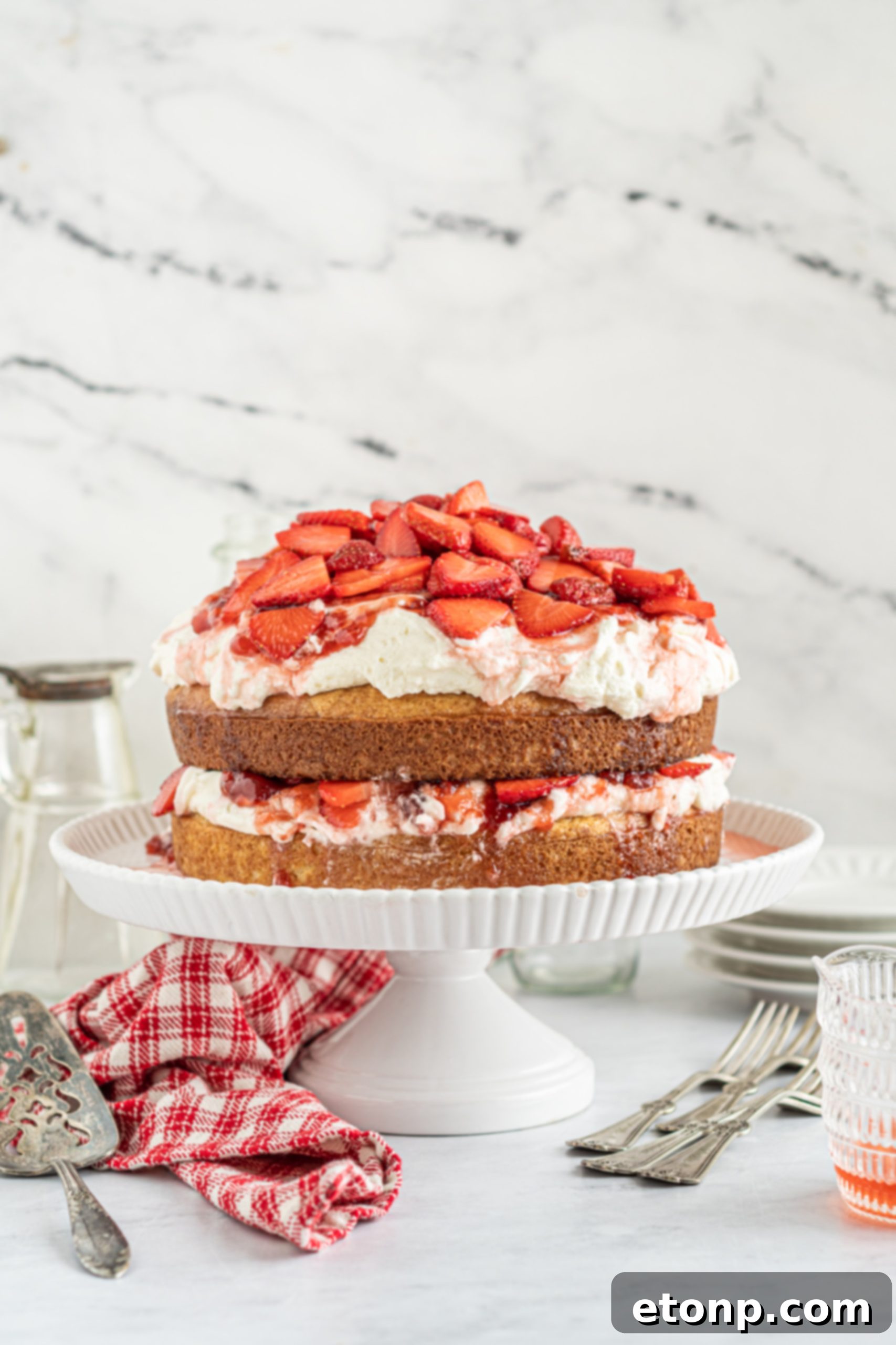 A top-down view of a beautifully prepared Strawberry Whipped Cream Cake.