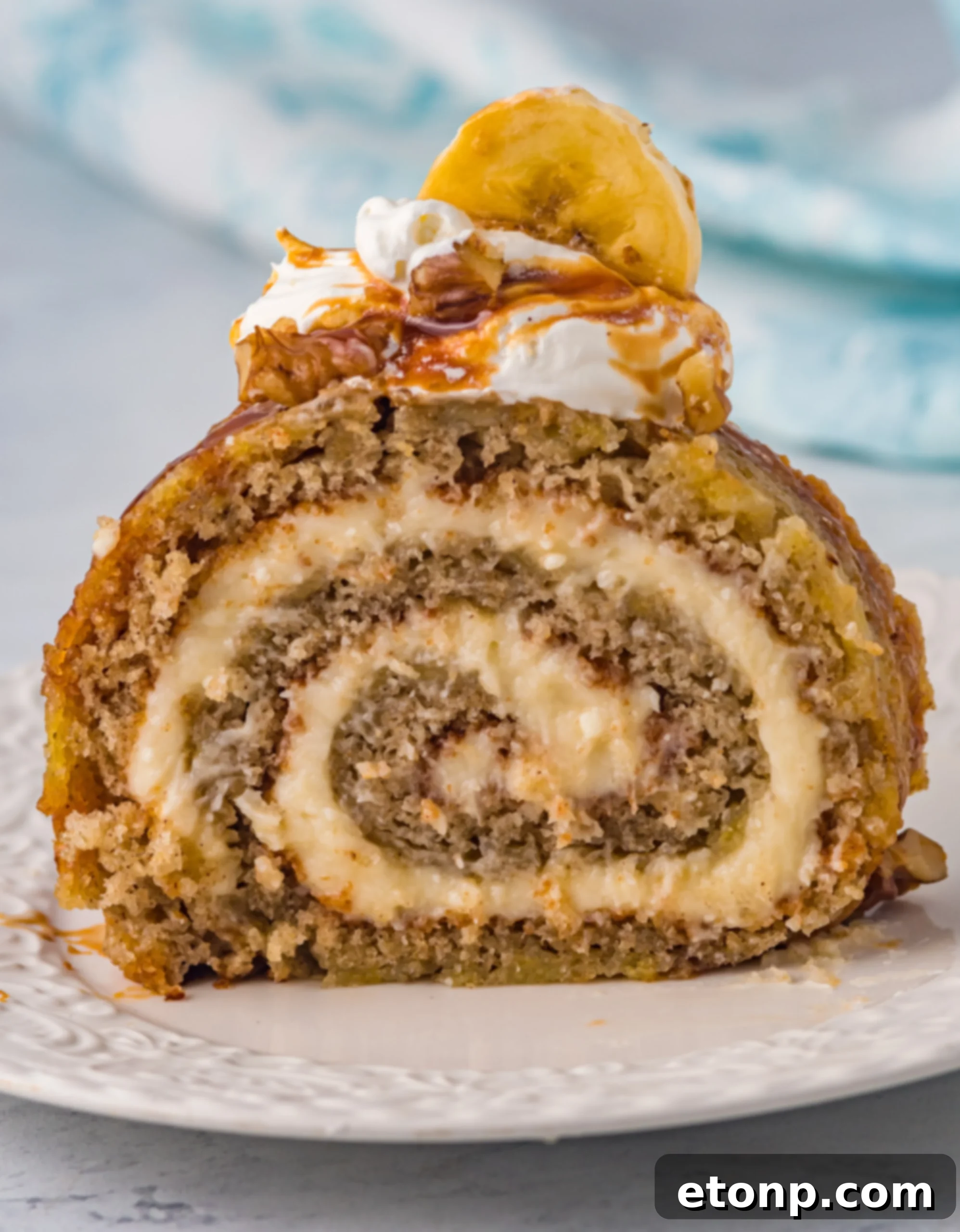 Delicious Homemade Banana Cake Roll with cream cheese filling and caramel sauce.