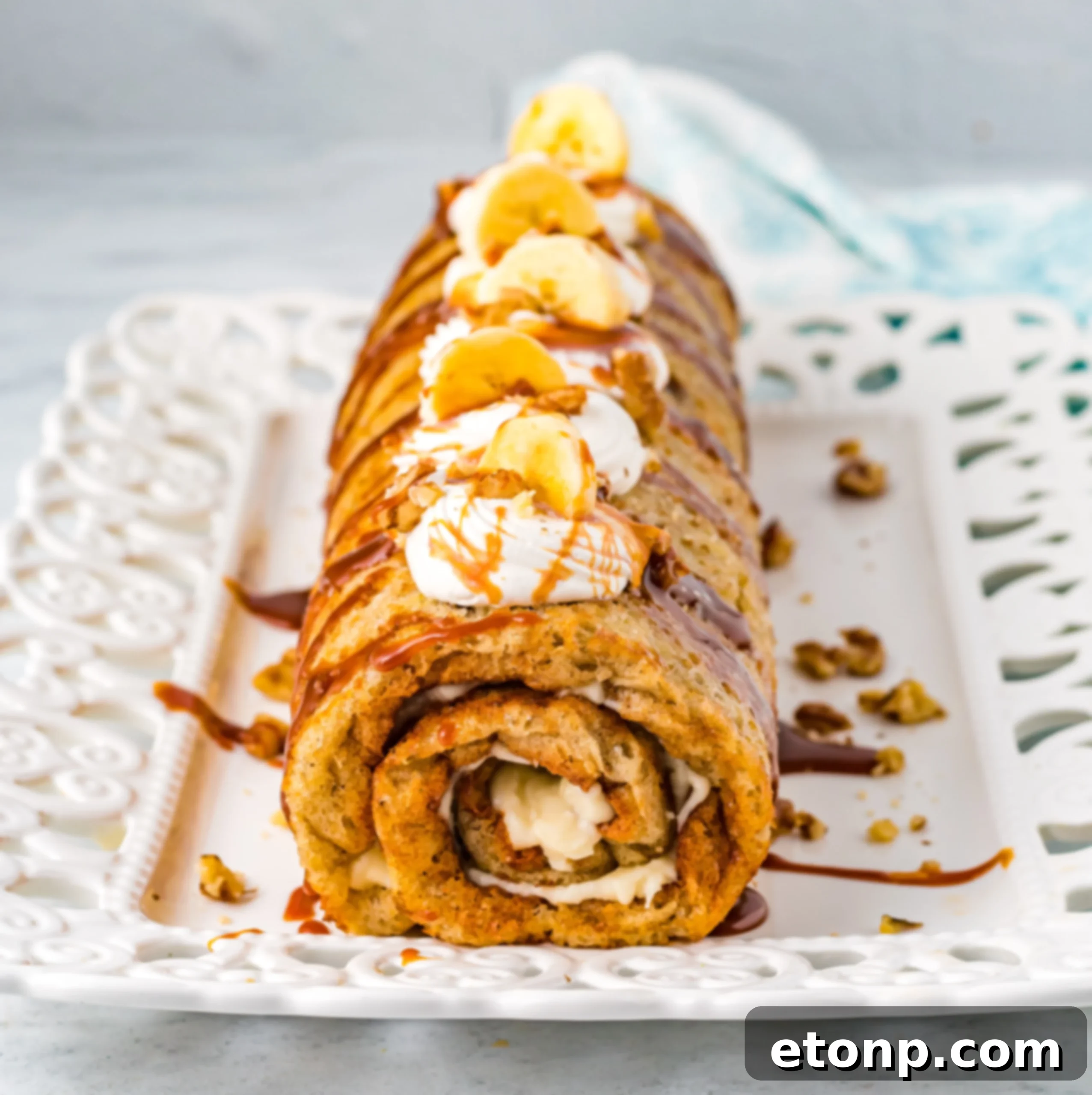 Freshly baked Banana Cake Roll on a cooling rack.