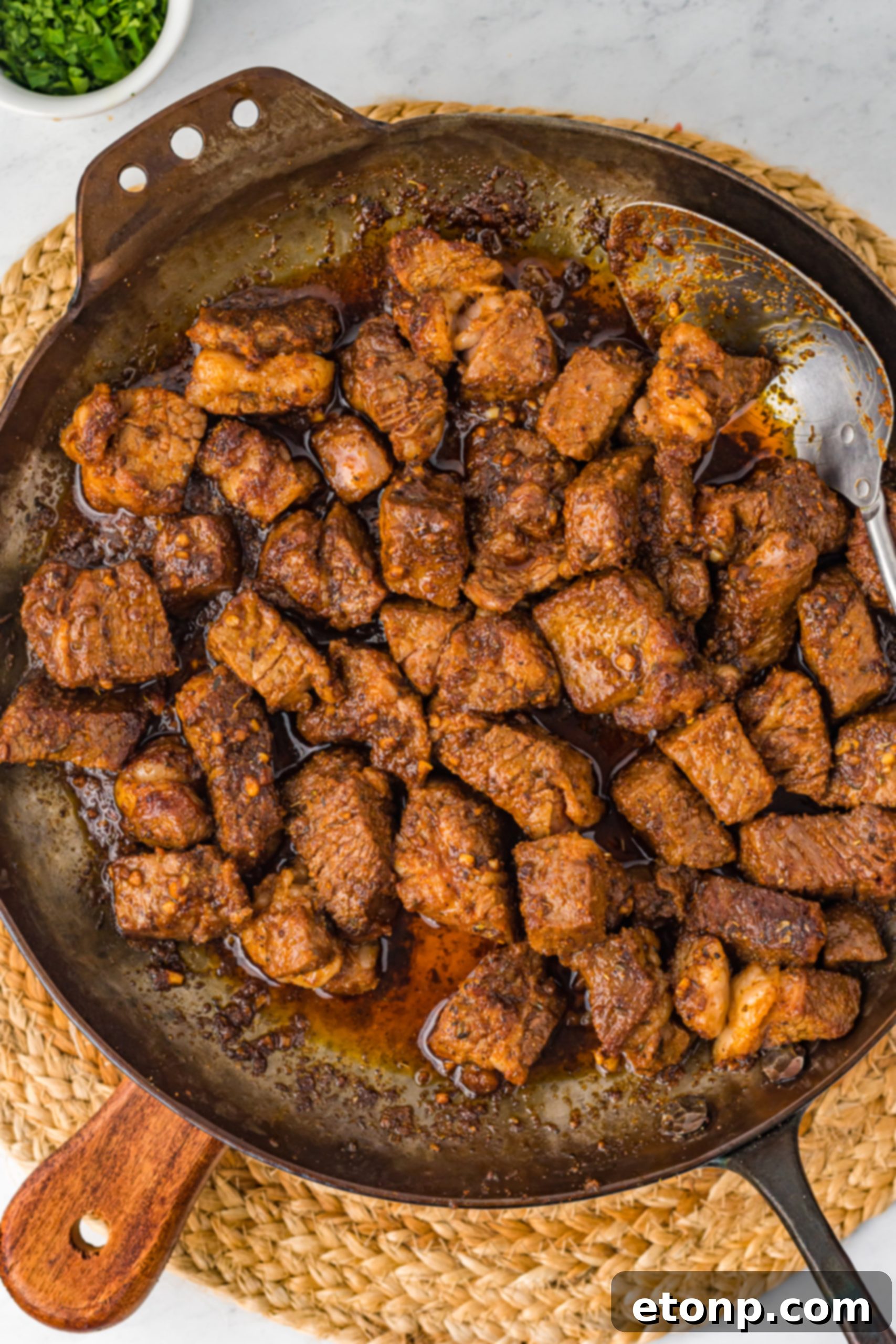 Savory Garlic Butter Steak Morsels 14 Cajun steak tips in a pan with butter and garlic