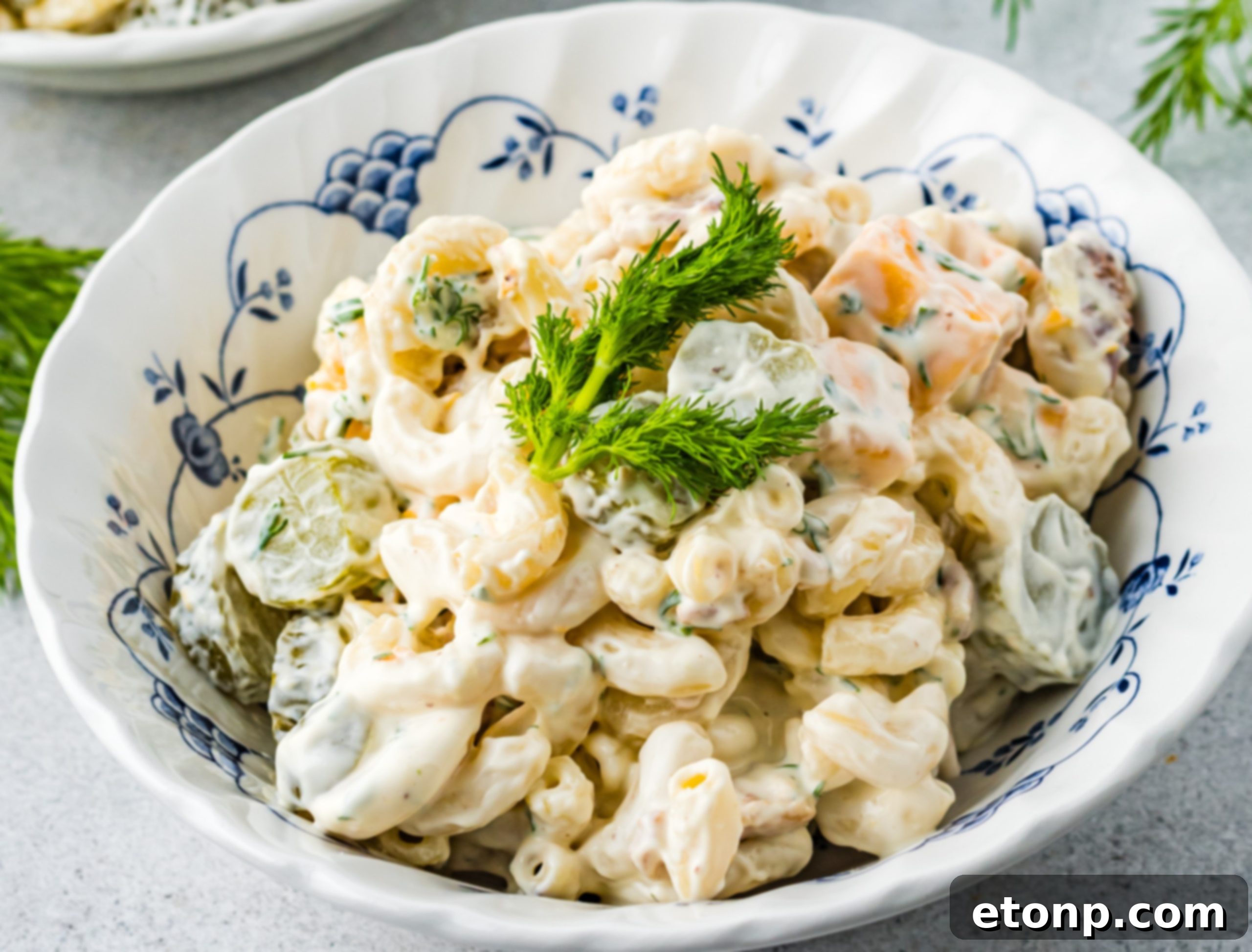 A close-up shot of the Dill Pickle Pasta Salad, emphasizing the chunks of cheese and pickles.